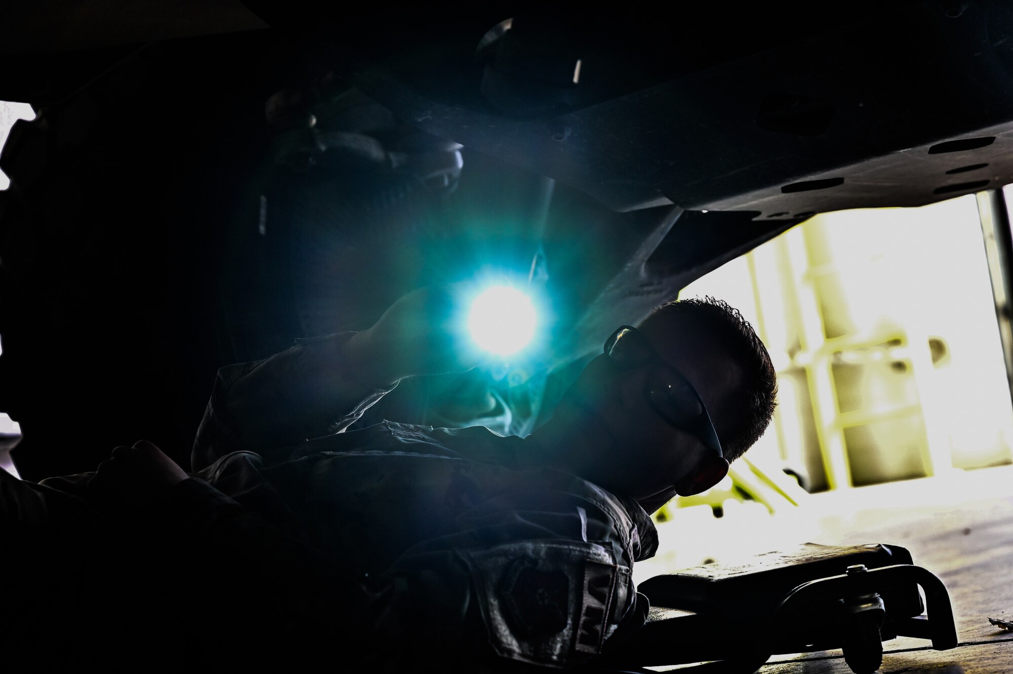 Senior Airman Korey Sarantopoulos, 90th Logistics Readiness Squadron vehicle maintenance journeyman, inspects the undercarriage to check the electrical, brake, fuel, cooling and other systems for serviceability as part of a Joint Light Tactical Vehicle limited technical inspection at F.E. Warren Air Force Base, Wyoming, Oct 25, 2022. The 90 LRS is tasked with preparing the next generation of security forces vehicles sent to protect the 90th Missile Wing's ICBM system as part of Air Force Global Strike Command’s priority to modernize. (U.S. Air Force photo by Joseph Coslett)