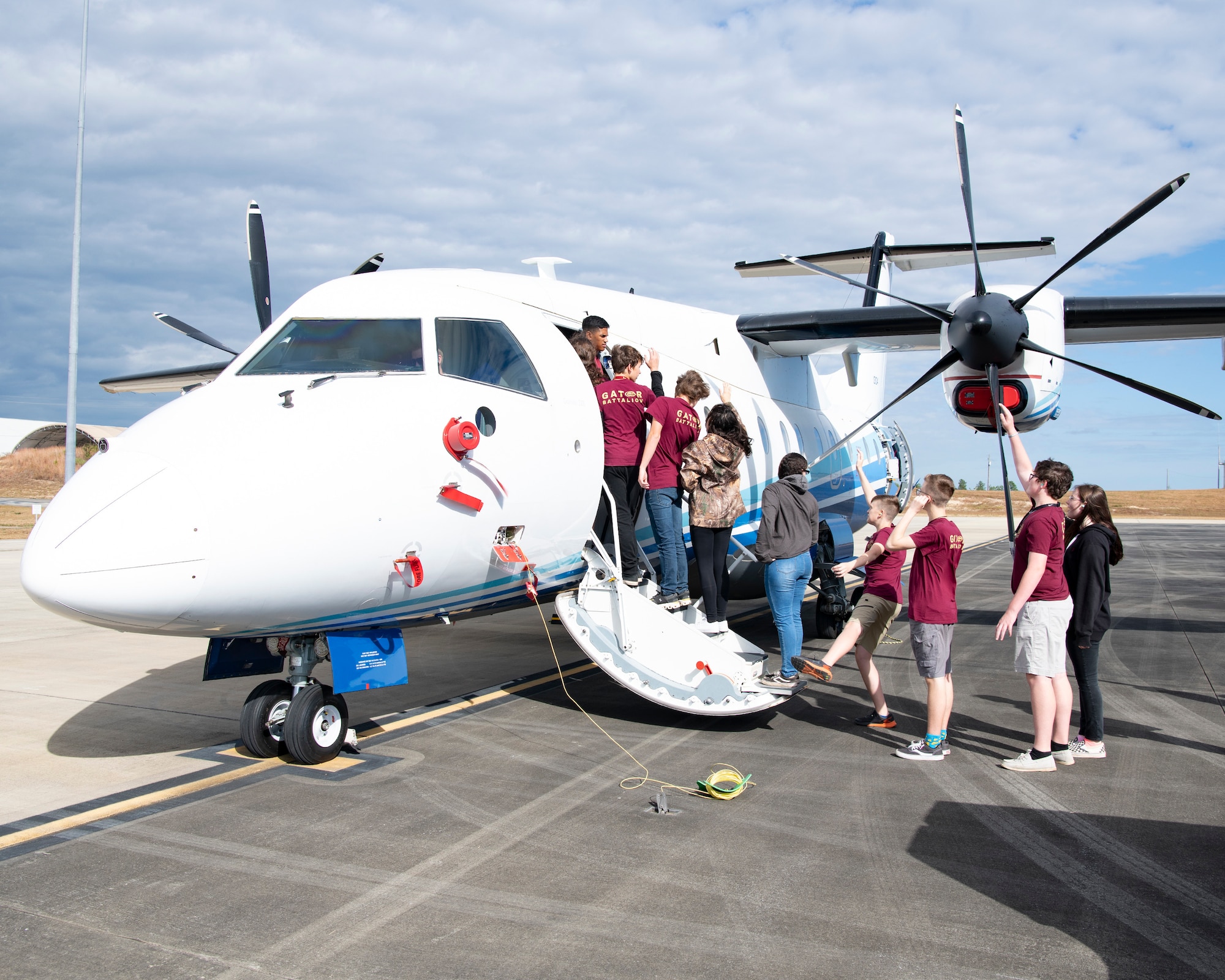Cadets walk up the stairs of a C-146A Wolfhound aircraft.
