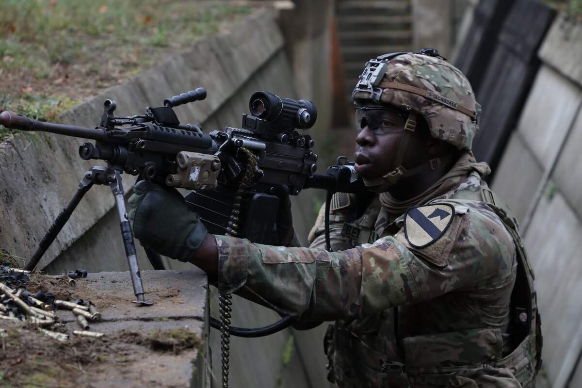 A soldier aims a gun.