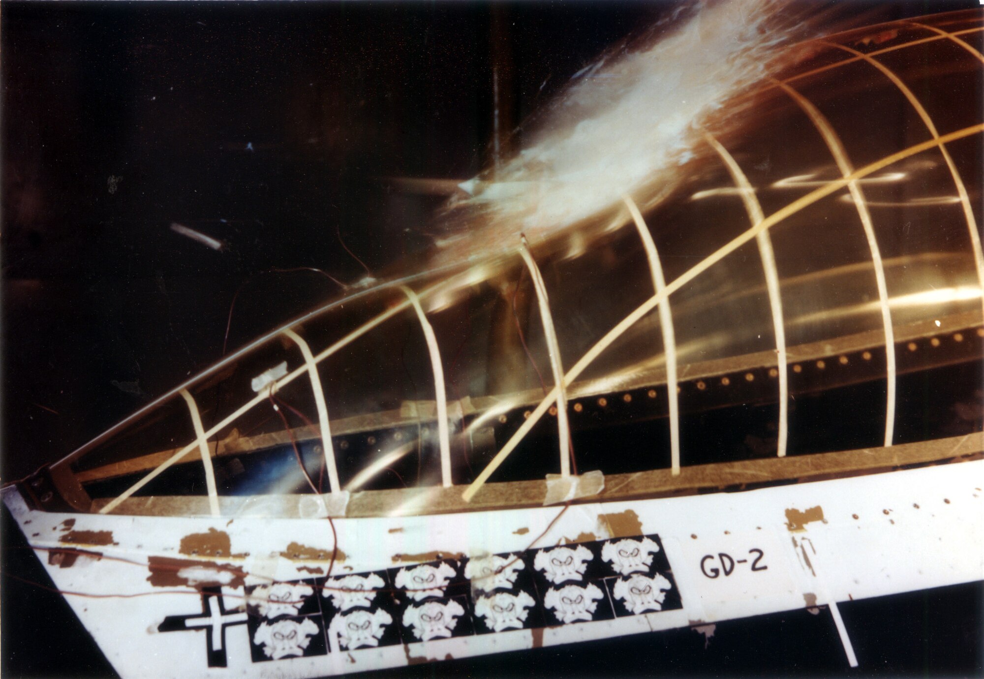 A chicken carcass launched at the Bird Impact Range at Arnold Air Force Base, Tennessee, strikes the canopy of an F-16 Fighting Falcon during bird strike impact testing in 1983. The range, more famously known as the “Chicken Gun,” was used to simulate in-flight bird strikes to aircraft canopies and other materials by launching chicken carcasses at test articles. The first shot from the Chicken Gun was fired 50 years ago. (U.S. Air Force photo)