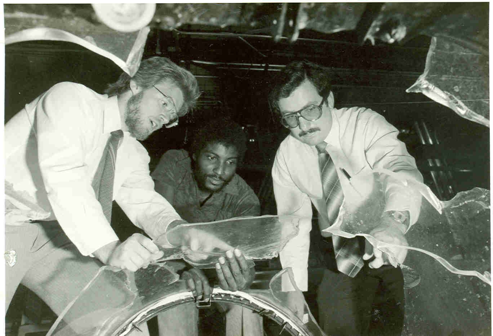 A windshield that did not stand up to simulated bird strike testing at the Bird Impact Range at Arnold Air Force Base, Tennessee, is inspected by project engineers Jon Storslee, left, and Butch Garrett, center, and then-Air Force test director Tom Best in 1982. The range, more famously known as the “Chicken Gun,” was used to simulate in-flight bird strikes to aircraft canopies and other materials by launching chicken carcasses at test articles. The first shot from the Chicken Gun was fired 50 years ago. (U.S. Air Force photo)