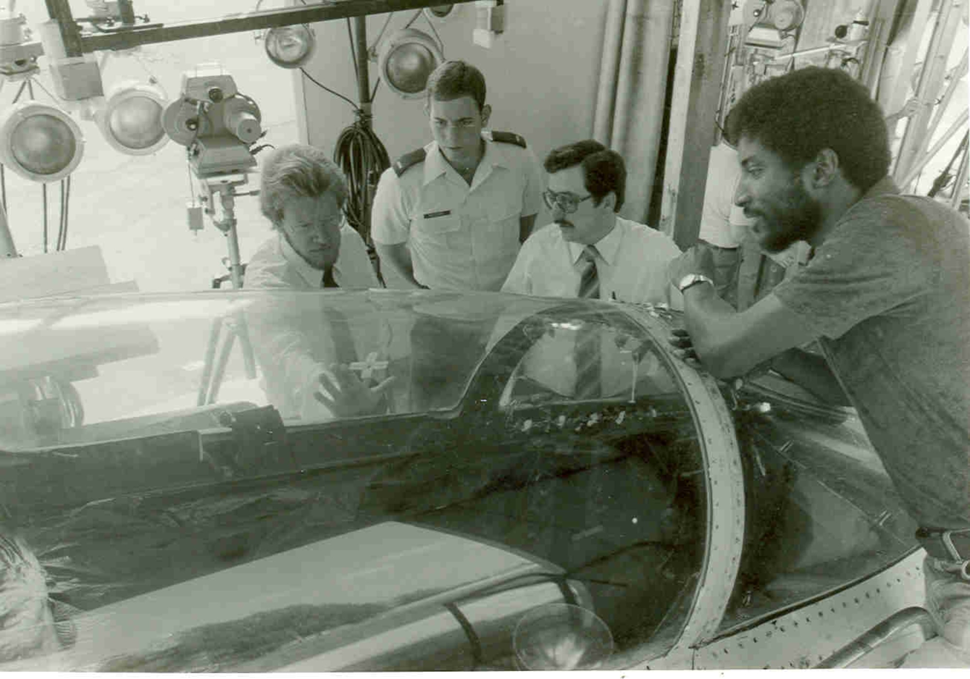 An aircraft canopy is readied for simulated bird strike testing by, from left, Jon Storslee, 2nd Lt. Mark Retzloff, then-Air Force test director Tom Best and Butch Garrett at the Bird Impact Range at Arnold Air Force Base, Tennessee, in 1982. The range, commonly referred to as the “Chicken Gun,” was used to simulate in-flight bird strikes to aircraft canopies and other materials by launching chicken carcasses at test articles. The first shot from the Chicken Gun was fired 50 years ago. (U.S. Air Force photo)