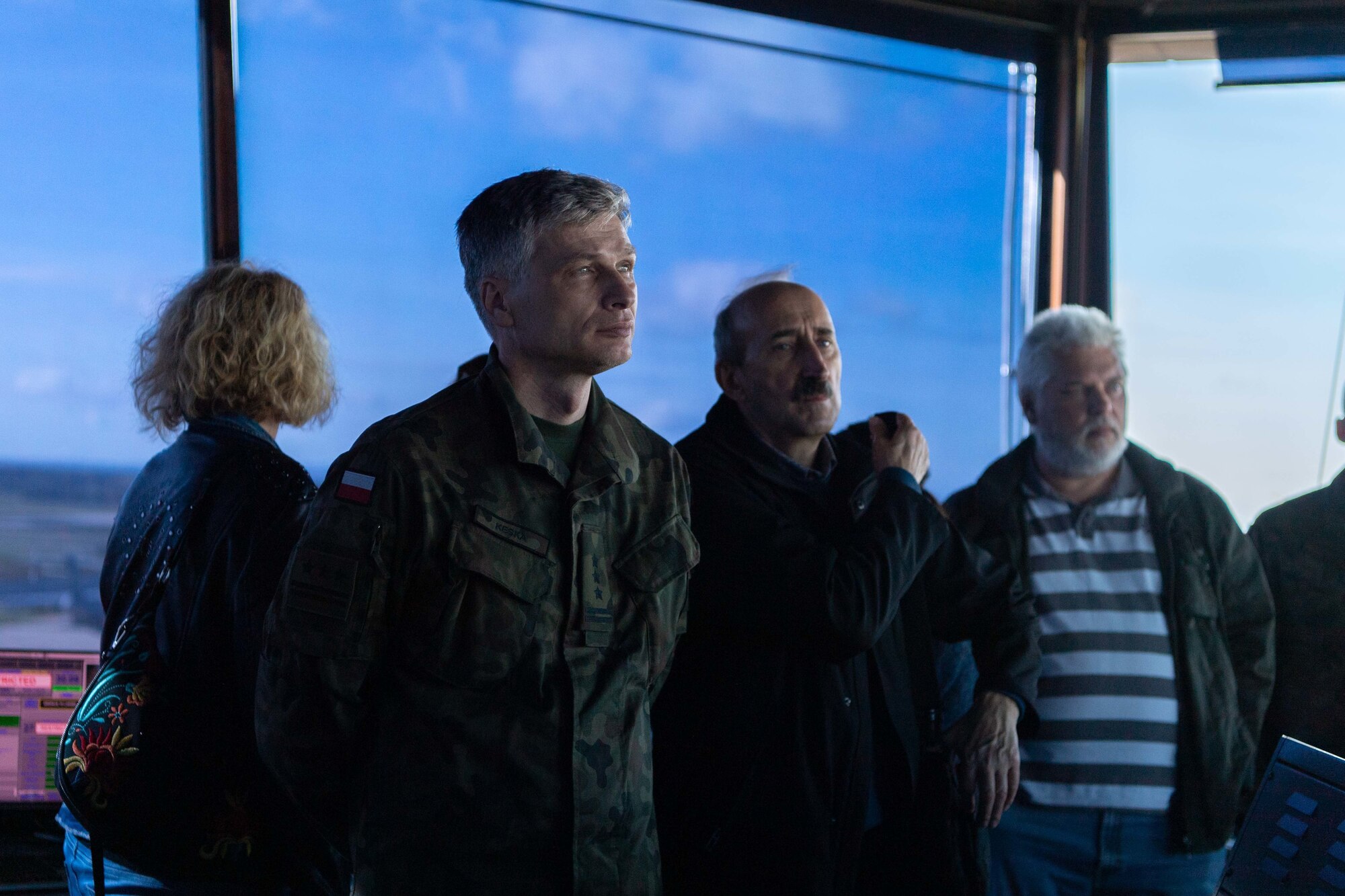 Members of the Polish air force listen to a U.S. Air Force air traffic controller explain the functions of the watch tower at Ramstein Air Base, Germany, Oct. 26, 2022