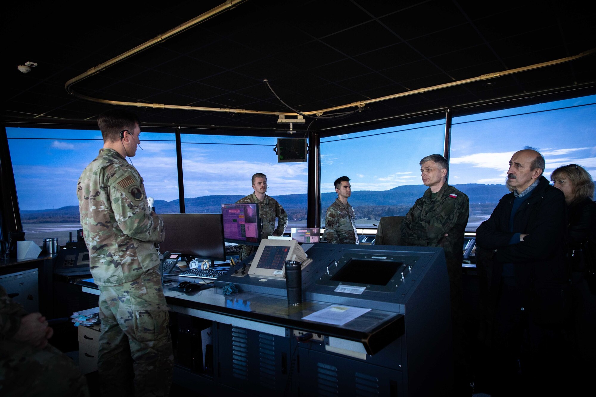 U.S. Air Force Staff Sgt. Derek Schafer, left, 86th Operation Support Squadron air traffic controller, provides an overview of the watch tower facility, equipment and capabilities to Polish air force leaders at Ramstein Air Base, Germany, Oct. 27, 2022.