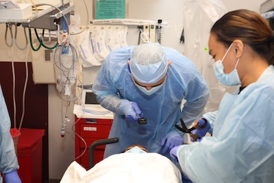 Image of two Airmen treating a patient.