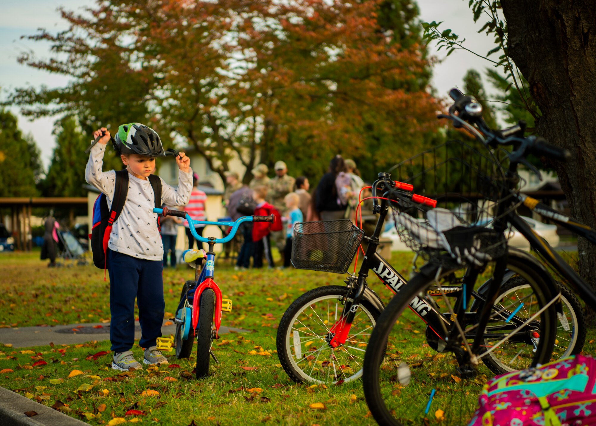 U.S. Air Force Airmen assigned to the 35th Security Forces Squadron give decorations to children during a bike rodeo at Misawa Air Base, Japan, Oct. 27, 2022. The bike rodeo was held in response to parent concerns to reinforce proper helmet wear and riding practices. (U.S. Air Force photo by Tech. Sgt. Jao’Torey Johnson)