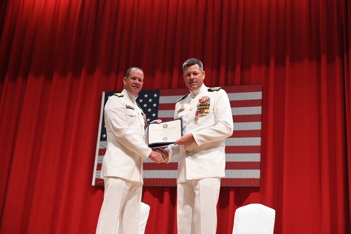 Capt. Tim DeWitt, Naval Facilities Engineering Systems Command Fast East, is relieved by Capt. Lance Flood during a change of command and retirement ceremony for DeWitt on board Fleet Activities Yokosuka, Japan, Oct. 28.