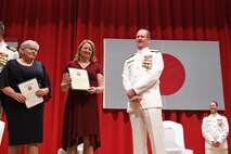 Capt. Tim DeWitt, Naval Facilities Engineering Systems Command Fast East, is relieved by Capt. Lance Flood during a change of command and retirement ceremony for DeWitt on board Fleet Activities Yokosuka, Japan, Oct. 28.