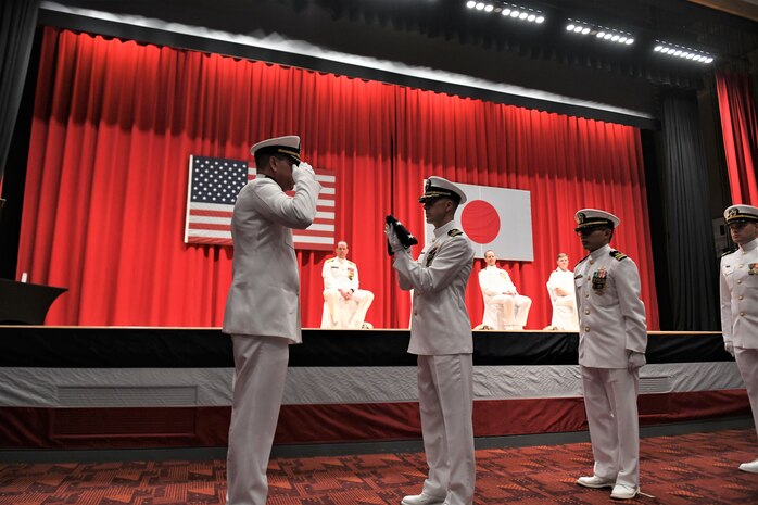 Capt. Tim DeWitt, Naval Facilities Engineering Systems Command Fast East, is relieved by Capt. Lance Flood during a change of command and retirement ceremony for DeWitt on board Fleet Activities Yokosuka, Japan, Oct. 28.