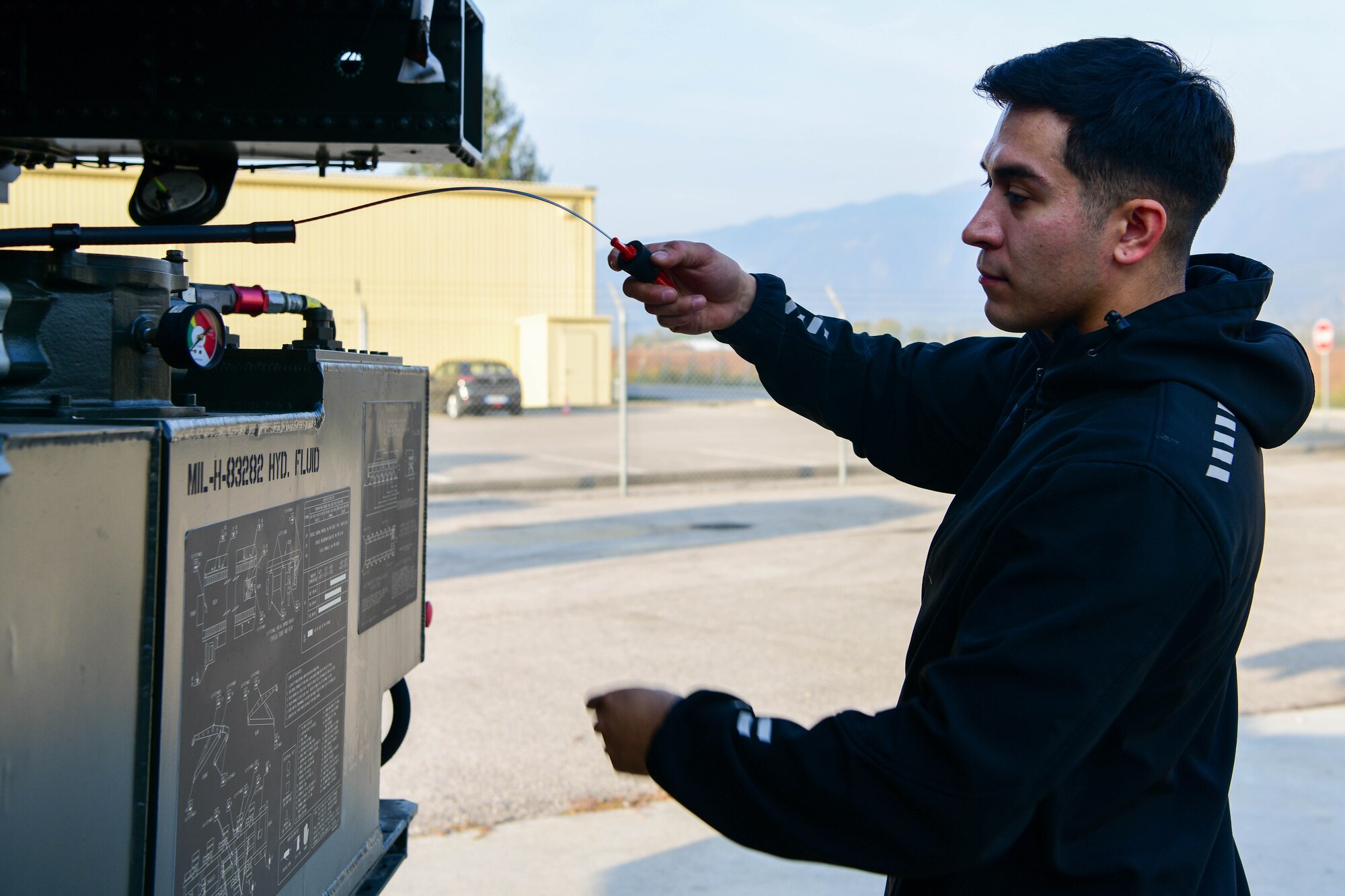 Senior Airman Armando Espinoza, 31st Logistics Readiness Squadron vehicle maintenance technician, inspects a Tunner 60k aircraft loader at Aviano Air Base, Italy, Oct. 20, 2022. The mechanics inspect the wipers, lights, seatbelts, engine, brakes, transmission, etc., on vehicles that come through the shop. (U.S. Air Force photo by Senior Airman Brooke Moeder)