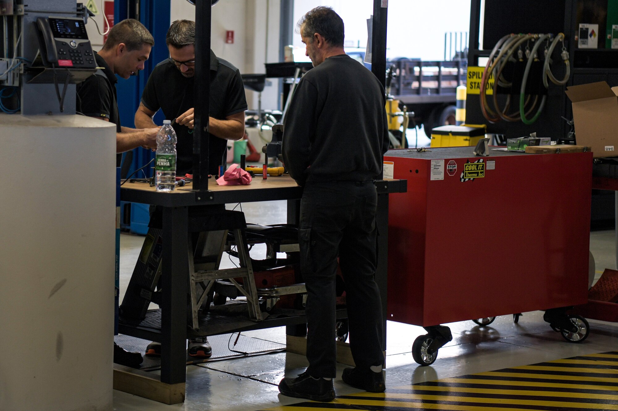 men work in an auto shop