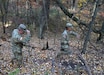 U.S. Army Reserve Pfc. Kyle Bowens, assigned to the 395th Ordnance Company, 103rd Sustainment Command (Expeditionary) based in Appleton, Wis., right, pushes a branch out of the way as he and Pfc. Dalton Zellner walk alongside a hill during land navigation familiarization training on Fort McCoy, Wis., Oct. 21, 2022.  (U.S. Army Reserve photo by Sgt. 1st Class Clinton Wood, 88th Readiness Division PAO).
