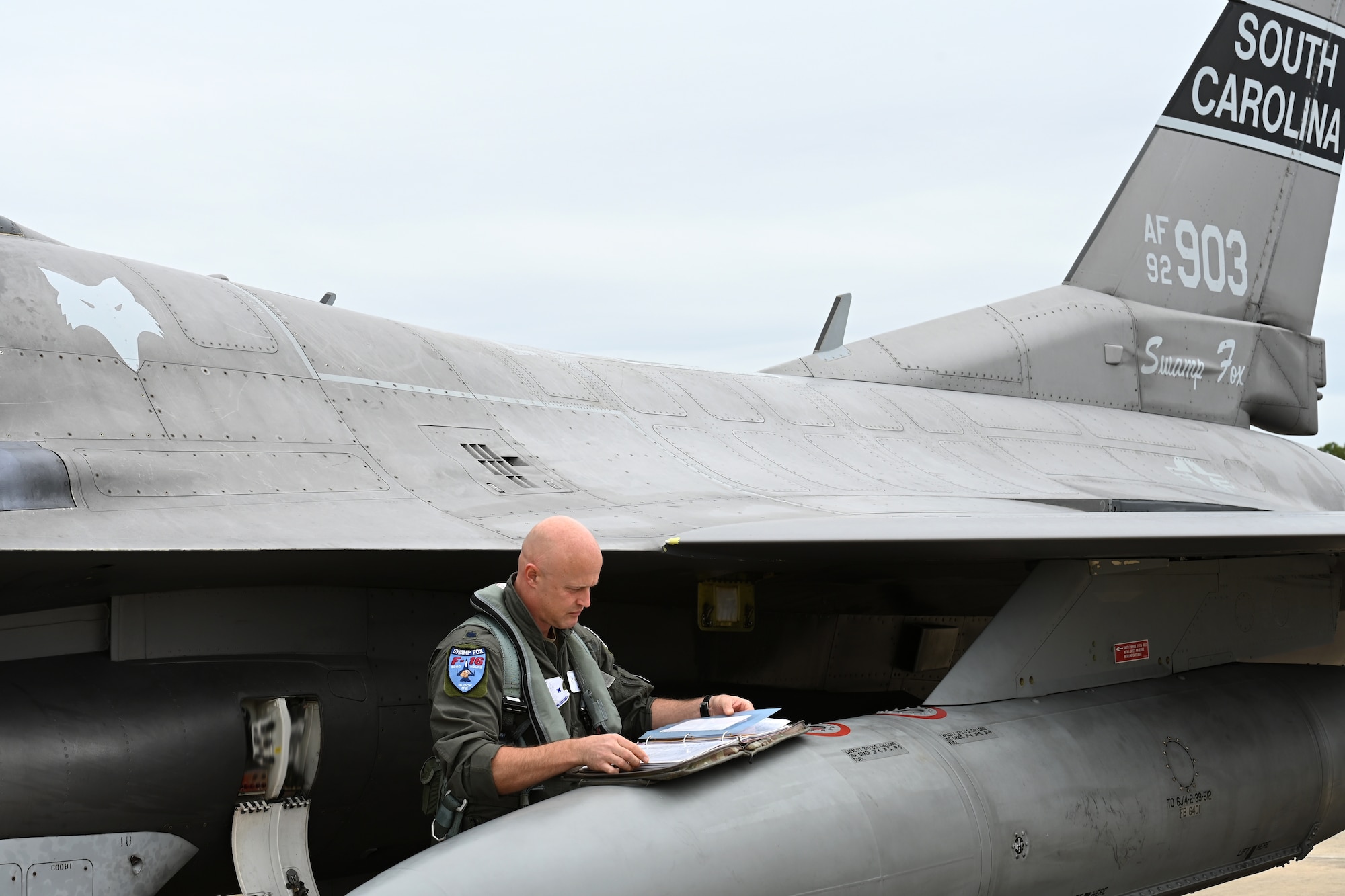 U.S. Air Force Lt. Col. David Anderson, 157th Fighter Squadron pilot, checks aircraft maintenance records as he prepares an F-16 fighter jet from the South Carolina Air National Guard’s 169th Fighter Wing to depart Columbia Metropolitan Airport in West Columbia, South Carolina, to an alternate airfield Sept. 29, 2022. The temporary relocation was a safety precaution ahead of the anticipated arrival of Hurricane Ian.