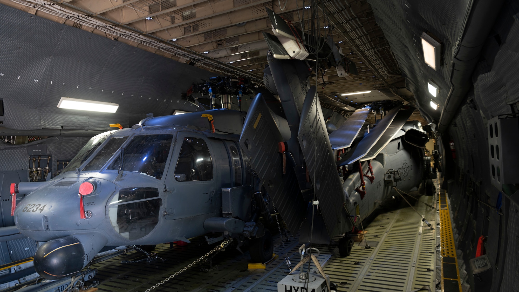 Two HH-60 Pave Hawk helicopters sit inside a C-5M Galaxy at an undisclosed location in Southwest Asia, Oct. 11, 2022. The C-5 provides heavy intercontinental-range strategic airlift capabilities and is able to carry oversized loads as one of the largest military aircraft in the world. (U.S. Air Force photo by Tech. Sgt. Jeffery Foster)
