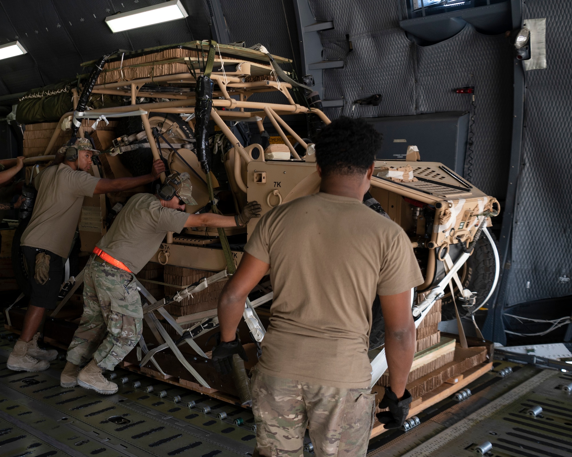 Airmen from the 60th Air Mobility Wing, Travis Air Force Base, Calif., unload a Utility Terrain Vehicle along with other cargo from a C-5M Galaxy at an undisclosed location in Southwest Asia, Oct. 11, 2022. UTVs are used to haul equipment and supplies in locations that make using larger vehicles impractical or impossible. (U.S. Air Force photo by Tech. Sgt. Jeffery Foster)