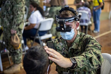 221027-N-LP924-1032 PUERTO BARRIOS, Guatemala (Oct. 27, 2022) Lt. Jared Widder, a native of Sheboygan, Wisconsin, attached to the hospital ship USNS Comfort (T-AH 20), conducts a preliminary eye exam on a local patient at a medical site in Puerto Barrios, Guatemala, Oct. 27, 2022. Comfort is deployed to U.S. 4th Fleet in support of Continuing Promise 2022, a humanitarian assistance and goodwill mission conducting direct medical care, expeditionary veterinary care, and subject matter expert exchanges with five partner nations in the Caribbean, Central and South America. (U.S. Navy photo by Mass Communication Specialist 3rd Class Sophia Simons)