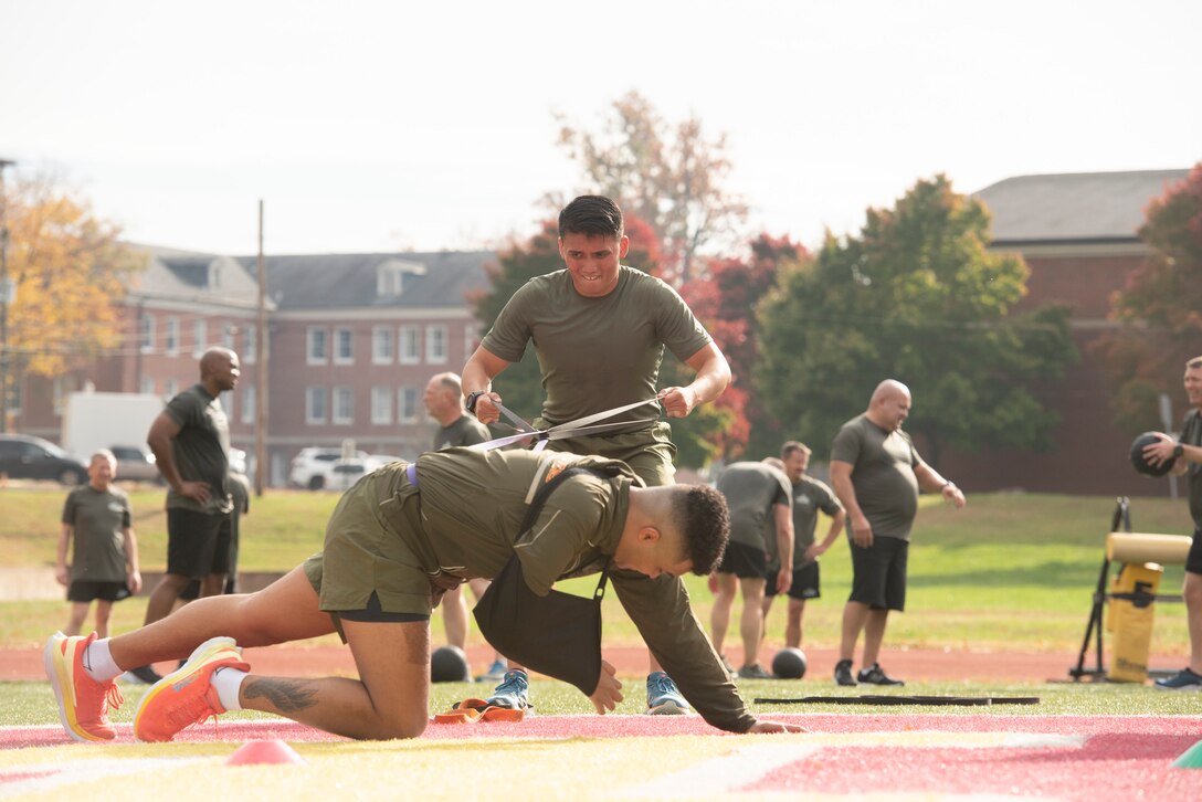 A participant "rows" using exercise bands while his partner serves as an anchor.