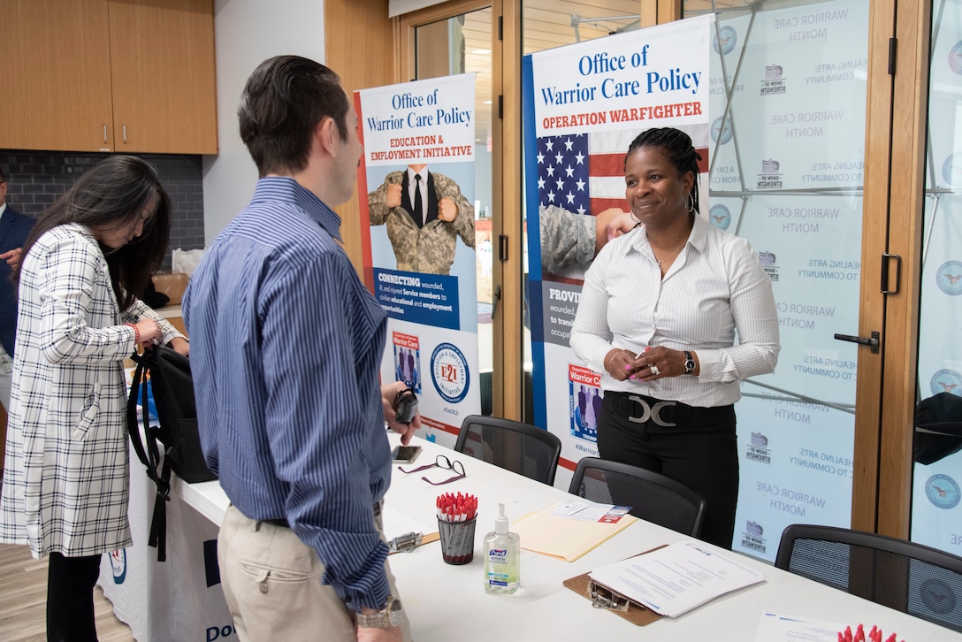 A participant speaks with an E2I/OWF representative.