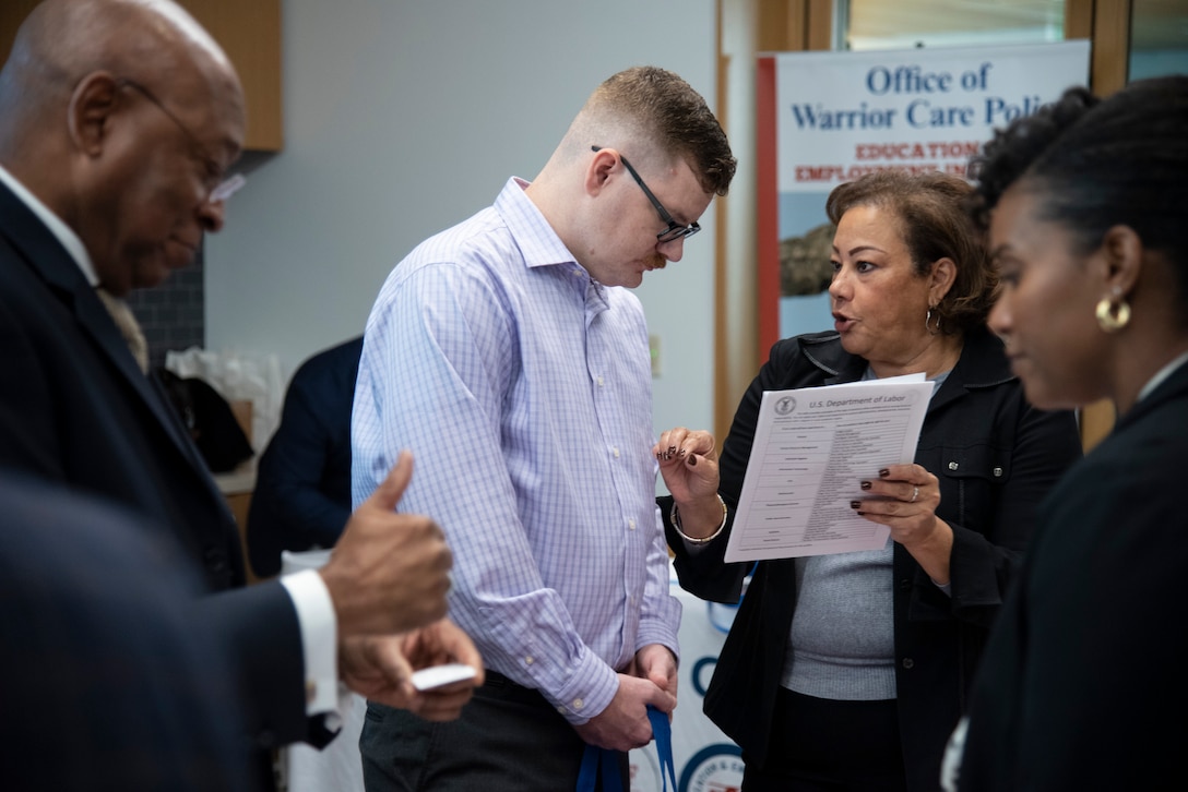 A service member discusses his resume with a Department of Labor representative.