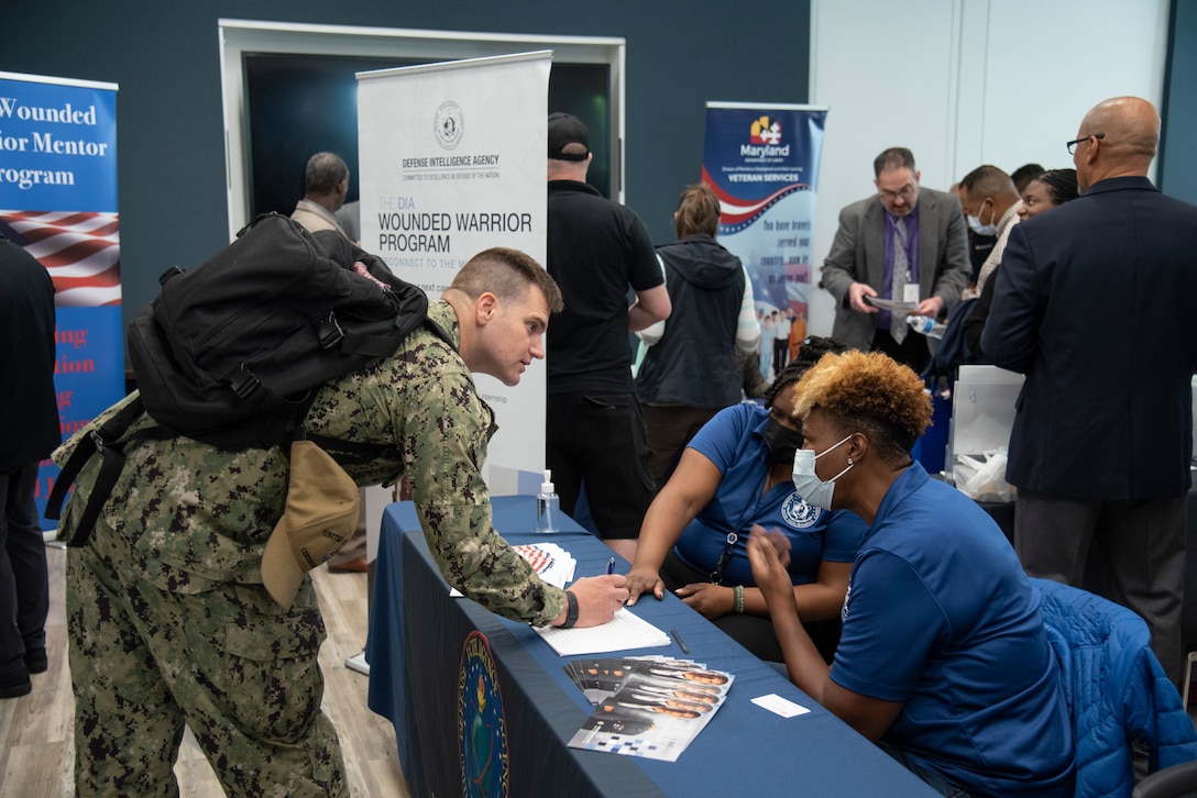 A service member speaks with Defense Intelligence Agency recruiters.