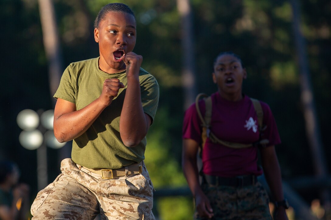A Marine recruit shouts as she practices martial arts.
