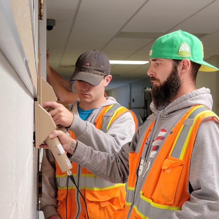 Contractors scan walls inside Jana Elementary School with radiation detection equipment. The structures investigation includes accessible surfaces. Sampling began Monday, Oct. 24, and preliminary results are expected within two weeks. (USACE photo by JP Rebello)