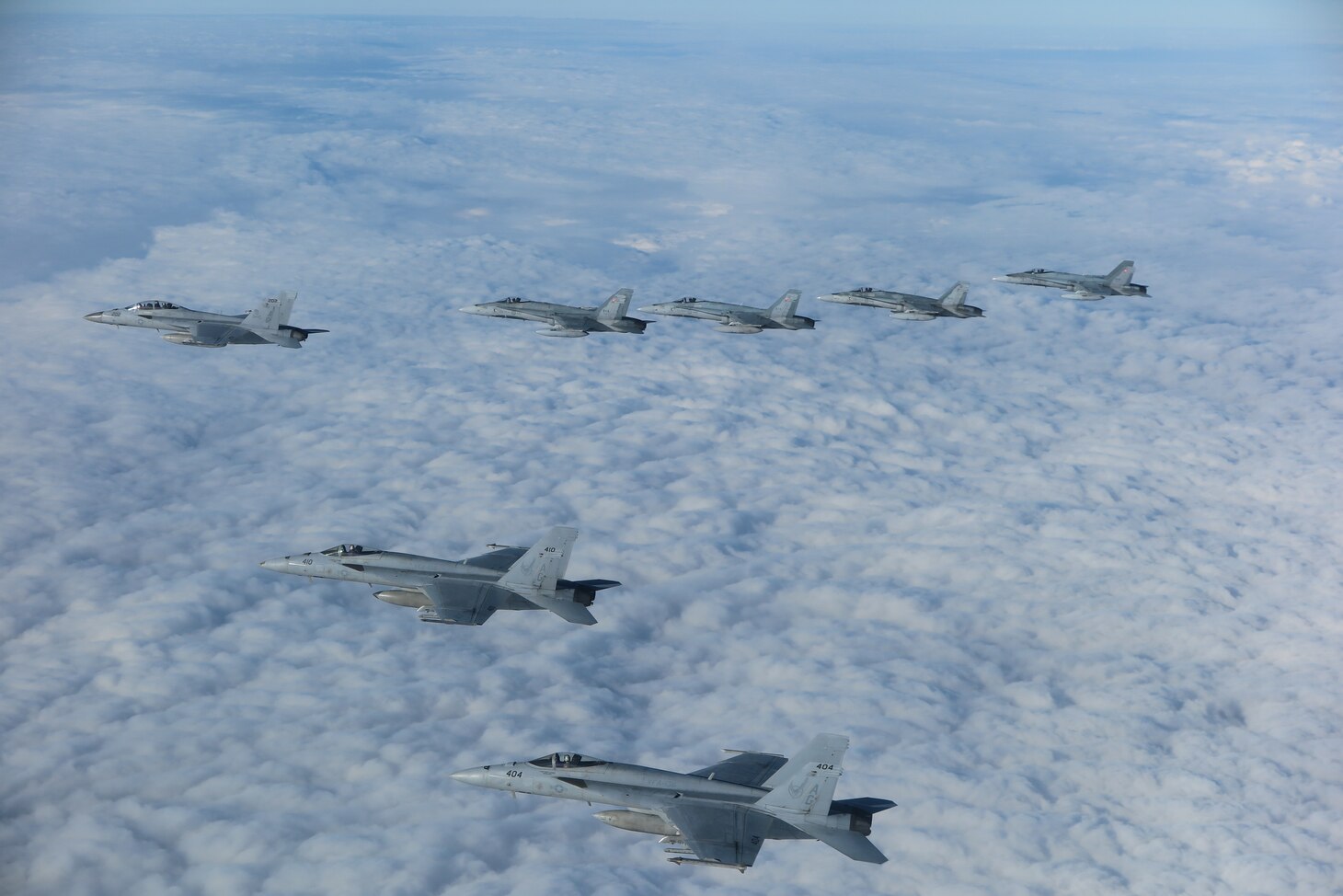 Three F/A-18E Super Hornet aircraft assigned to Carrier Air Wing (CVW) 7 and four CF-18 Hornet aircraft assigned to the Royal Canadian Air Force fly in formation over Romania during the NATO-led vigilance activity Neptune Strike 22.2 (NEST 22.2), Oct. 14, 2022.