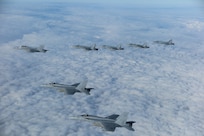 Three F/A-18E Super Hornet aircraft assigned to Carrier Air Wing (CVW) 7 and four CF-18 Hornet aircraft assigned to the Royal Canadian Air Force fly in formation over Romania during the NATO-led vigilance activity Neptune Strike 22.2 (NEST 22.2), Oct. 14, 2022.