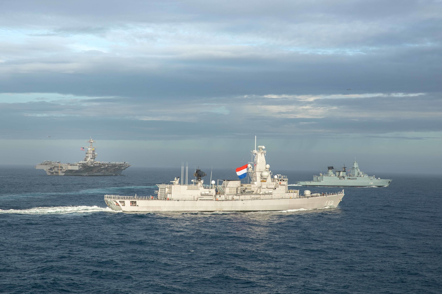 A view from the Ticonderoga-class guided-missile cruiser USS Normandy (CG 60) as the first-in-class aircraft carrier USS Gerald R. Ford (CVN 78), left, the Dutch navy ship Van Amstel (F 831), and the German Sachsen-class frigate FGS Hessen (F 221) steam in formation as part of the Gerald R. Ford Carrier Strike Group, Oct. 25, 2022.