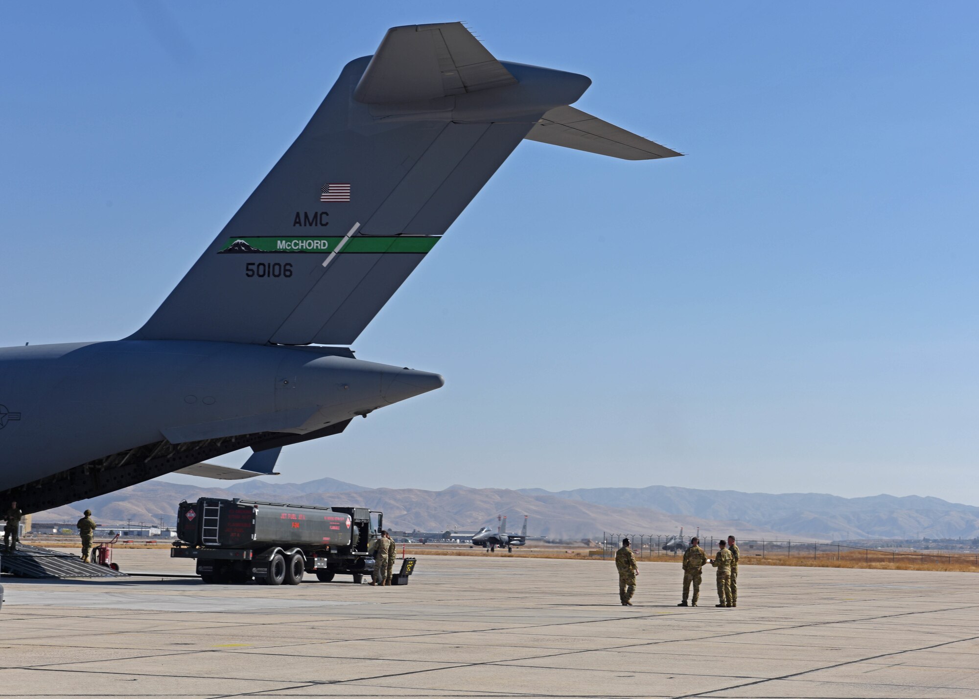 U.S. Airmen with the 62d Airlift Wing and 627th Air Base Group prepare to execute special fueling operations while an F-15E Strike Eagle aircraft lands on the flightline at Gowen Field, Boise, Idaho, Oct. 20, 2022. Special fueling operations were conducted by the 62d AW’s C-17 Globemaster III aircraft and the 366th Fighter Wing’s F-15 as part of Exercise Rainier War 22B. (U.S. Air Force photo by Staff Sgt. Zoe Thacker)