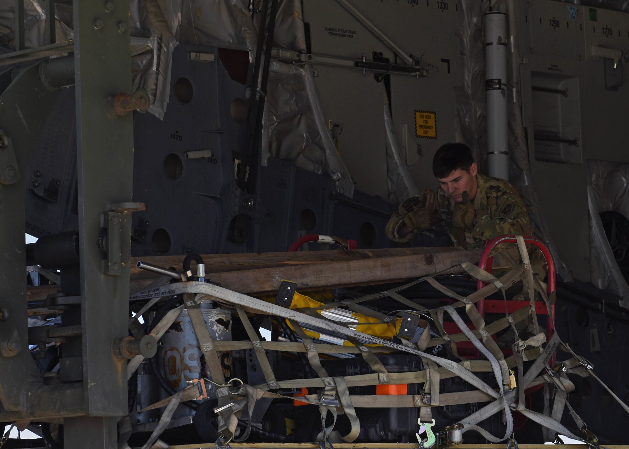 U.S. Air Force Airman 1st Class Tanner Brown, loadmaster with the 7th Airlift Squadron, guides the unloading of cargo from a C-17 Globemaster III aircraft from the 62d Airlift Wing during Exercise Rainier War 22B at Gowen Field, Boise, Idaho, Oct. 20, 2022. Exercise Rainier War is designed to evaluate and exercise Team McChord’s ability to generate, employ and sustain Rapid Global Mobility into and in support of U.S. Indo-Pacific areas of responsibility. (U.S. Air Force photo by Staff Sgt. Zoe Thacker)