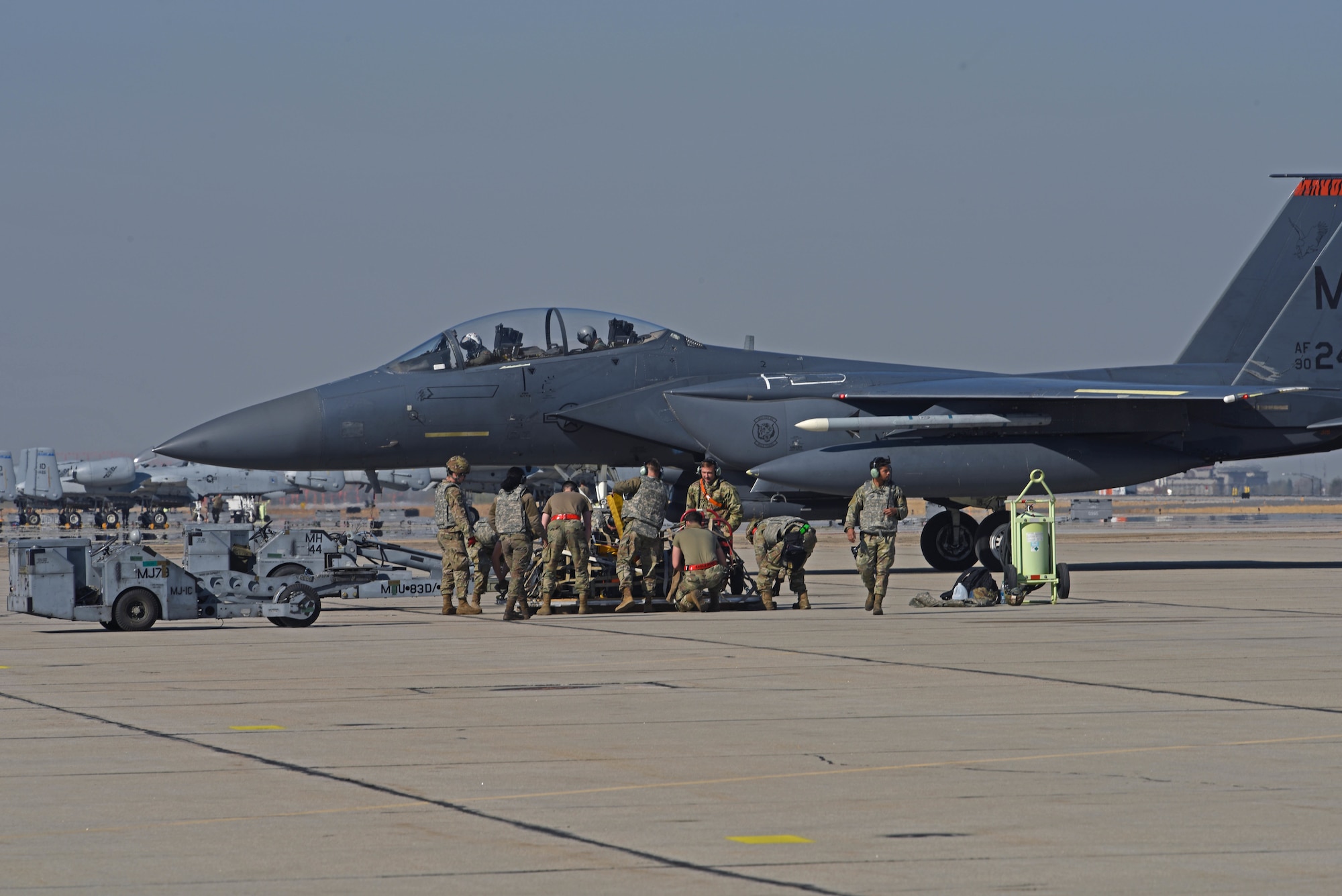 U.S. Airmen with the 366th Munitions Squadron prepare to load munitions onto an F-15E Strike Eagle from the 366th Fighter Wing during Exercise Rainier War 22B at Gowen Field, Boise, Idaho, Oct. 20, 2022. Exercise Rainier War is a major exercise for the 62d Airlift Wing at Joint Base Lewis-McChord, Washington, including multiple airlift assets and joint partners. (U.S. Air Force photo by Staff Sgt. Zoe Thacker)