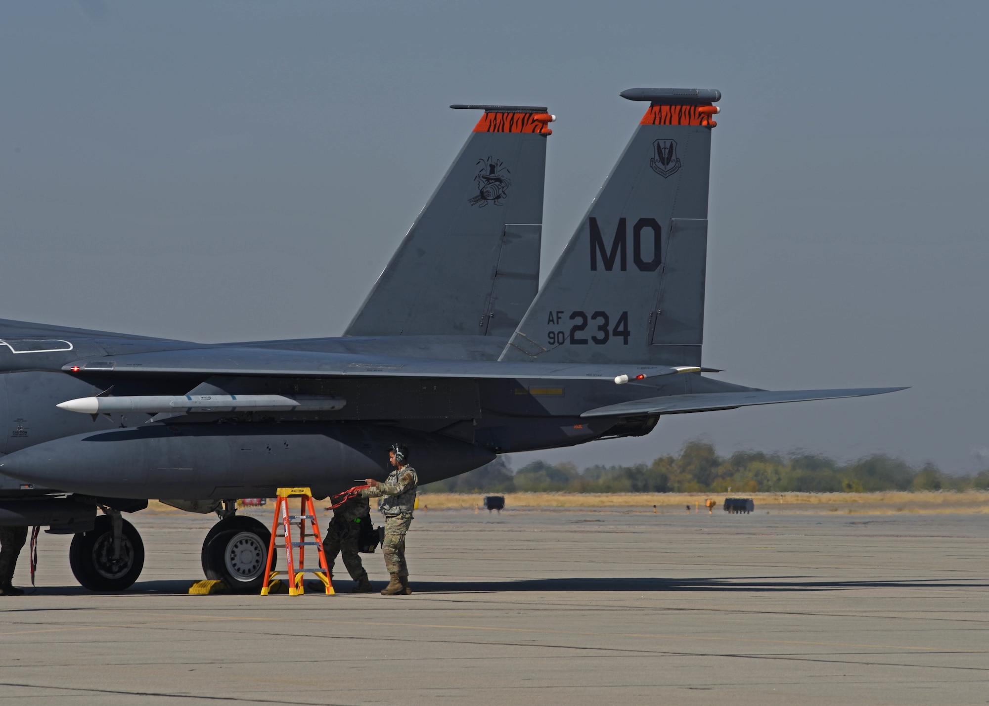 U.S. Airmen with the 366th Munitions Squadron prepare to load munitions onto an F-15E Strike Eagle from the 366th Fighter Wing at Mountain Home Air Force Base, Idaho, during Exercise Rainier War 22B at Gowen Field, Boise, Idaho, Oct. 20, 2022. Rainier War is a semi-annual exercise designed to demonstrate the 62d Airlift Wing, 627th Air Base Group and 446th Airlift Wing’s ability to generate, employ and sustain operations; alongside joint partners like the 366th FW. (U.S. Air Force photo by Staff Sgt. Zoe Thacker)