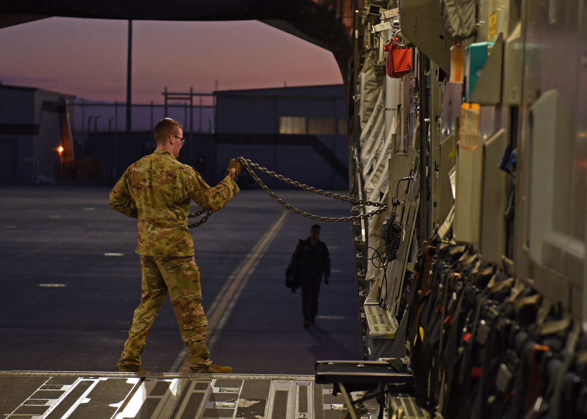 U.S. Air Force Staff Sgt. Connor Smith, loadmaster with the 7th Airlift Squadron, prepares to secure cargo in a C-17 Globemaster III aircraft during Exercise Rainier War 22B at Mountain Home Air Force Base, Idaho, Oct. 19, 2022. Airmen from multiple Team McChord units came together to form the 7th Expeditionary Airlift Squadron during Rainier War 22B; which is a full-scale readiness exercise simulating a deployment in support of U.S. Indo-Pacific areas of responsibility. (U.S. Air Force photo by Staff Sgt. Zoe Thacker)