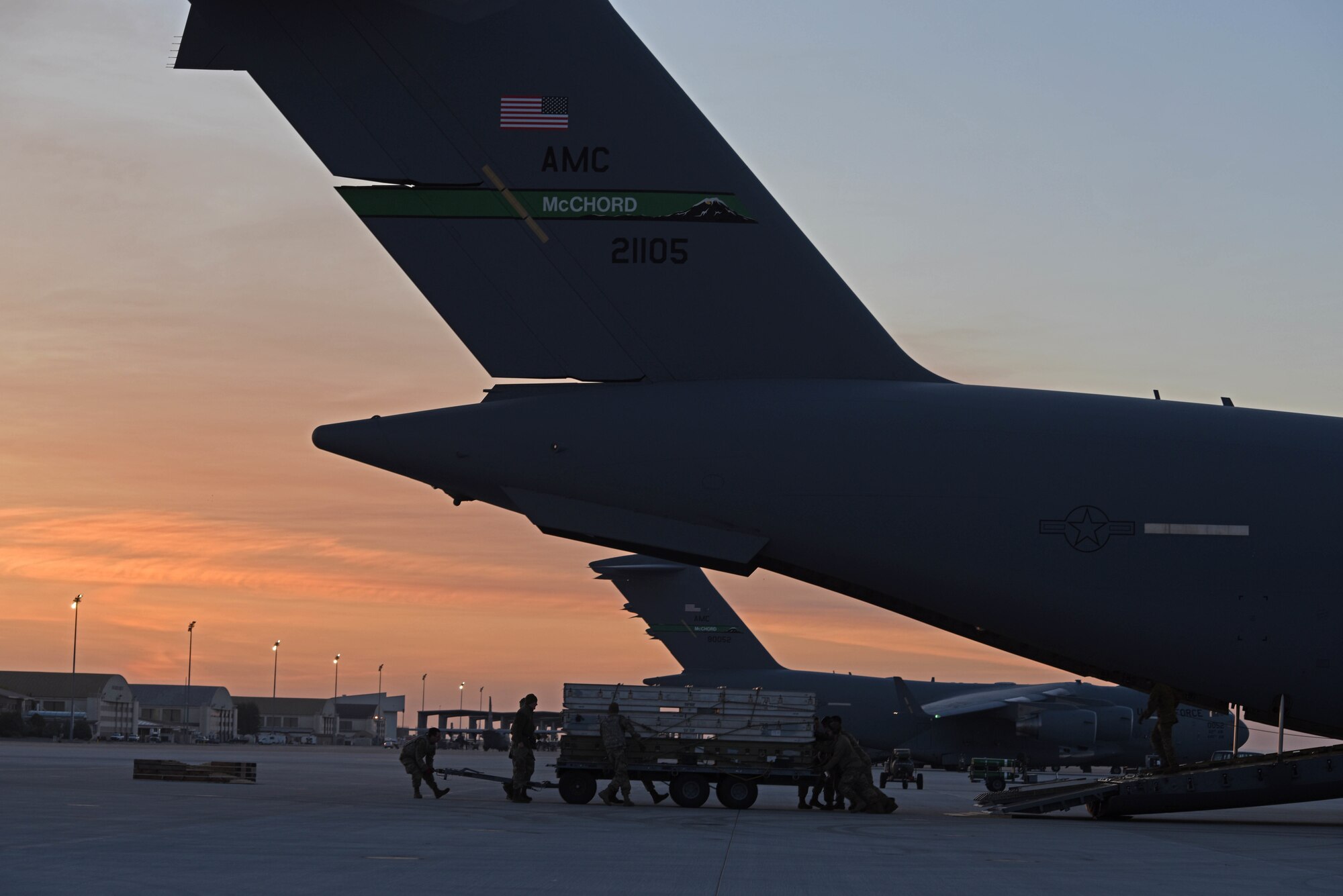 U.S. Airmen with the simulated 7th Expeditionary Airlift Squadron prepare to load cargo onto a C-17 Globemaster III aircraft during Exercise Rainier War 22B at Mountain Home Air Force Base, Idaho, Oct. 19, 2022. Airmen from multiple Team McChord units came together to form the 7th EAS during Rainier War 22B; which is a full-scale readiness exercise simulating a deployment in support of U.S. Indo-Pacific areas of responsibility. (U.S. Air Force photo by Staff Sgt. Zoe Thacker)