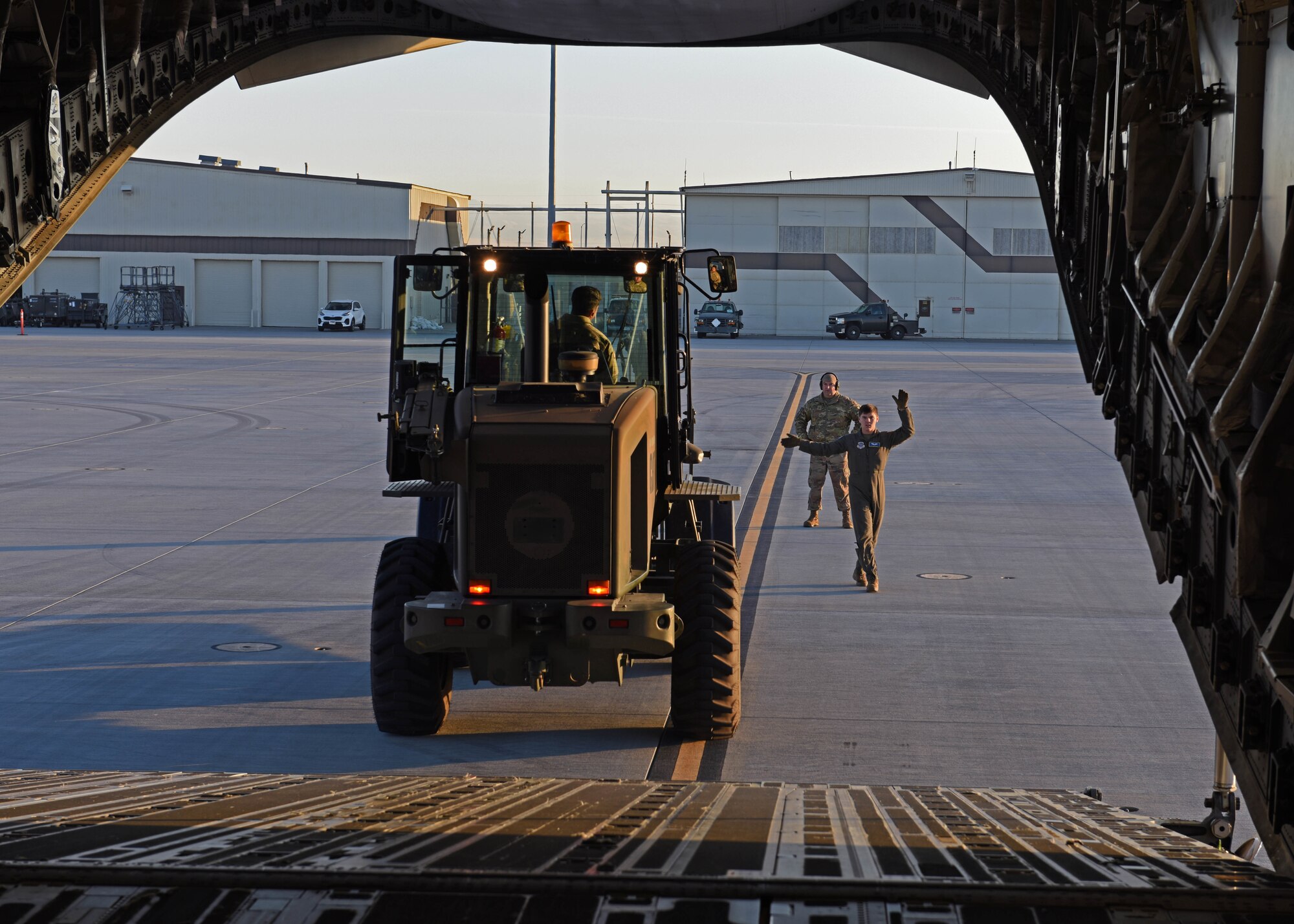 U.S. Airmen with the 62d Airlift Wing load a forklift onto a C-17 Globemaster III aircraft at Mountian Home Air Force Base, Idaho, Oct. 19, 2022. Exercise Rainier War is a major exercise for the 62d Airlift Wing, including multiple airlift assets, joint partners and special operations forces. (U.S. Air Force photo by Staff Sgt. Zoe Thacker)