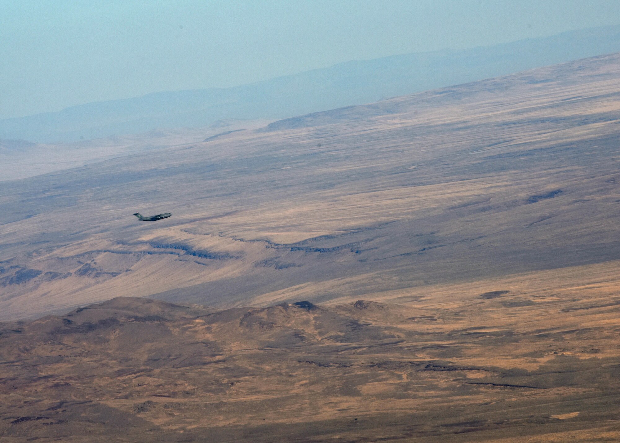 A C-17 Globemaster III aircraft from the 62d Airlift Wing flies over Idaho during Exercise Rainier War 22B, Oct. 19, 2022. Alongside airlift operations, Team McChord also conducted cargo and personnel processing, chemical, biological, radiological and nuclear, and force protection scenarios, communication and connectivity degradation incidents and crisis scenarios during Rainier War 22B. (U.S. Air Force photo by Staff Sgt. Zoe Thacker)