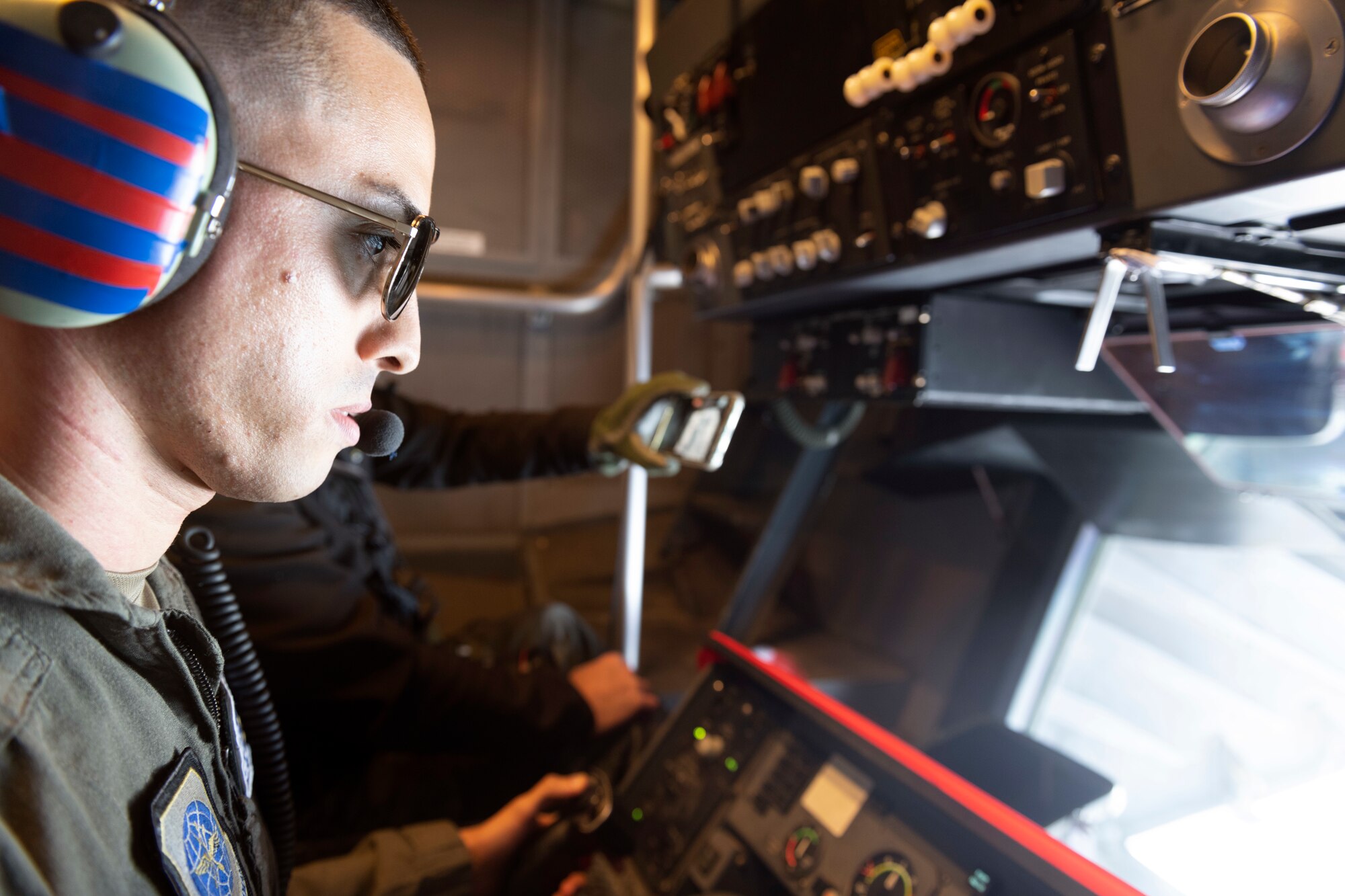 Airman looks out of the boom operator station.