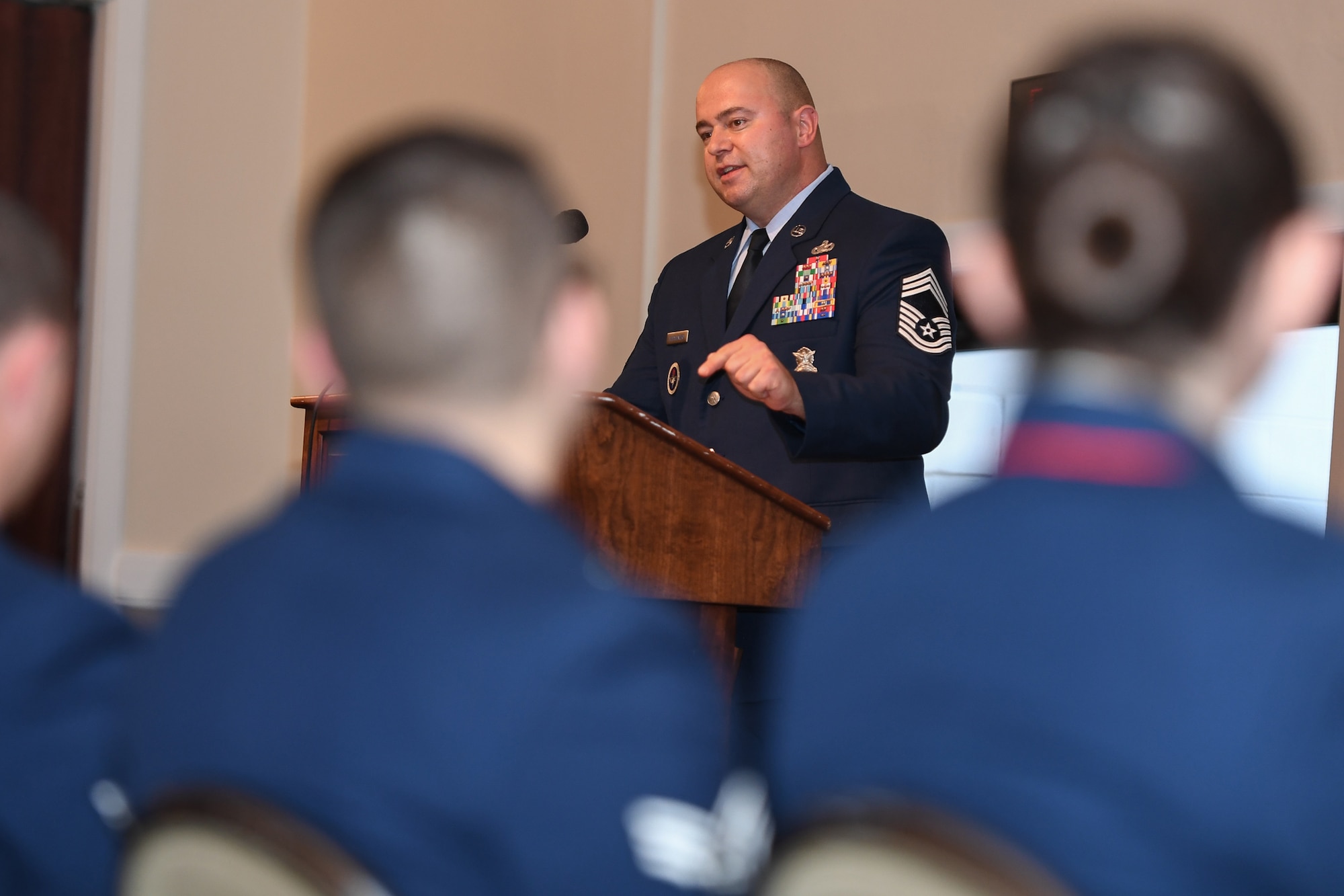 Image of Airman speaking at ceremony