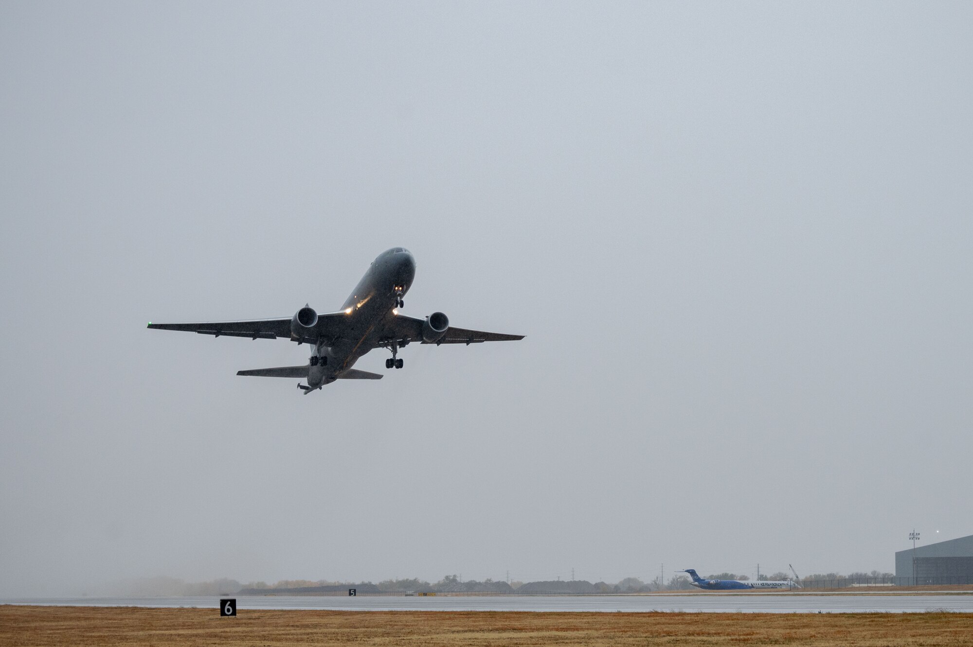 A KC-46A Pegasus takes off from McConnell Air Force Base, Kansas with a full crew compliment, Oct 24, 2022. Once it arrived at the military test range, this KC-46 along with one other from McConnell validated procedures for operating with a limited aircrew. One KC-46 operated with a limited aircrew, while the second KC-46 operated with a full crew complement of subject matter experts able to provide assistance by radio, if needed. (U.S. Air Force photo by Airman 1st Class Brenden Beezley)