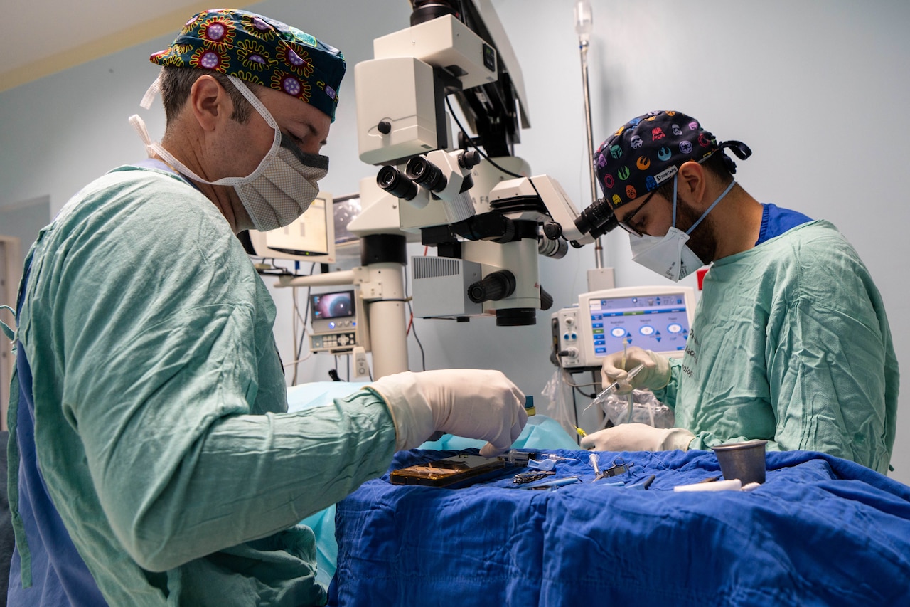 Two surgeons perform eye surgery.