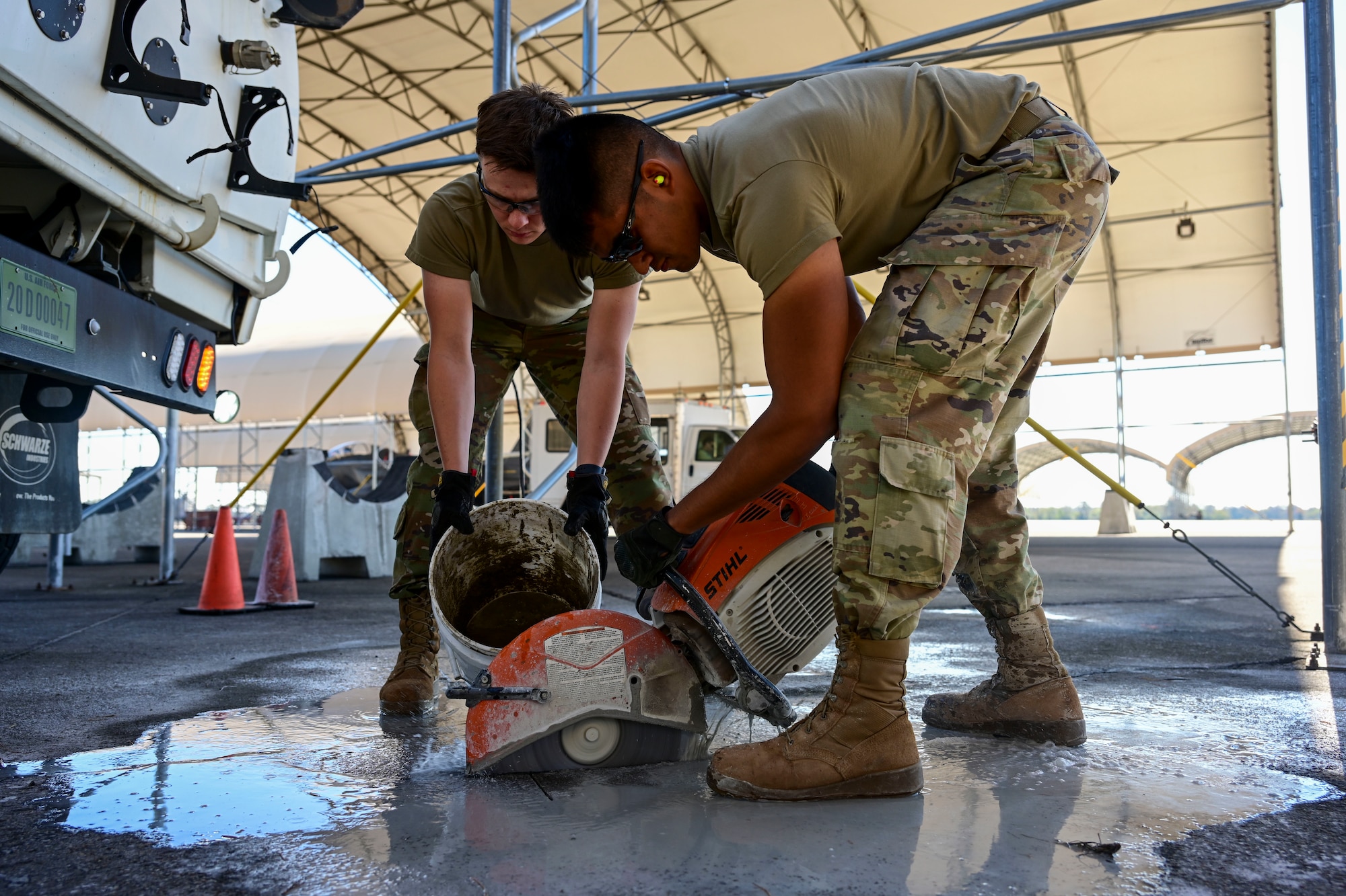 Pavement and equipment technicians assigned to the 4th Civil Engineer Squadron repair a patch of concrete at Seymour Johnson Air Force Base, North Carolina, Oct. 26, 2022. Pavements and equipment technicians earned the name “Dirt Boyz” during the Vietnam War because they were always covered in dirt, mud and concrete. (U.S. Air Force photo by Senior Airman Kevin Holloway)