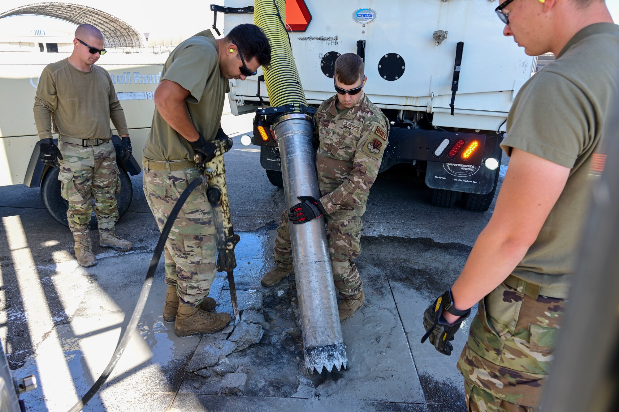 Pavement and equipment technicians assigned to the 4th Civil Engineer Squadron repair a patch of concrete at Seymour Johnson Air Force Base, North Carolina, Oct. 26, 2022. Pavements and equipment technicians earned the name “Dirt Boyz” during the Vietnam War because they were always covered in dirt, mud and concrete. (U.S. Air Force photo by Senior Airman Kevin Holloway)