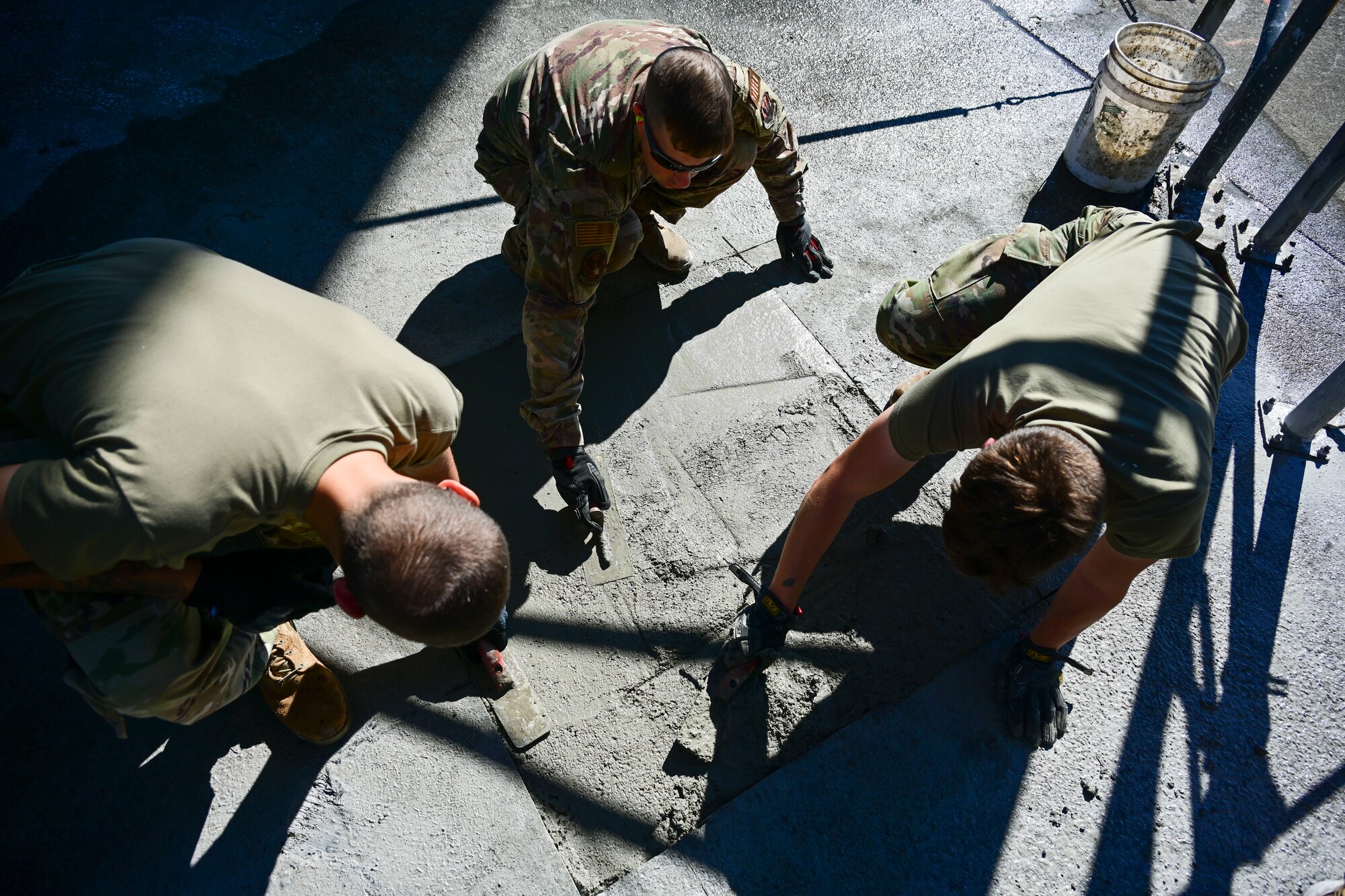 Pavement and equipment technicians assigned to the 4th Civil Engineer Squadron repair a patch of concrete at Seymour Johnson Air Force Base, North Carolina, Oct. 26, 2022. Pavements and equipment technicians earned the name “Dirt Boyz” during the Vietnam War because they were always covered in dirt, mud and concrete. (U.S. Air Force photo by Senior Airman Kevin Holloway)
