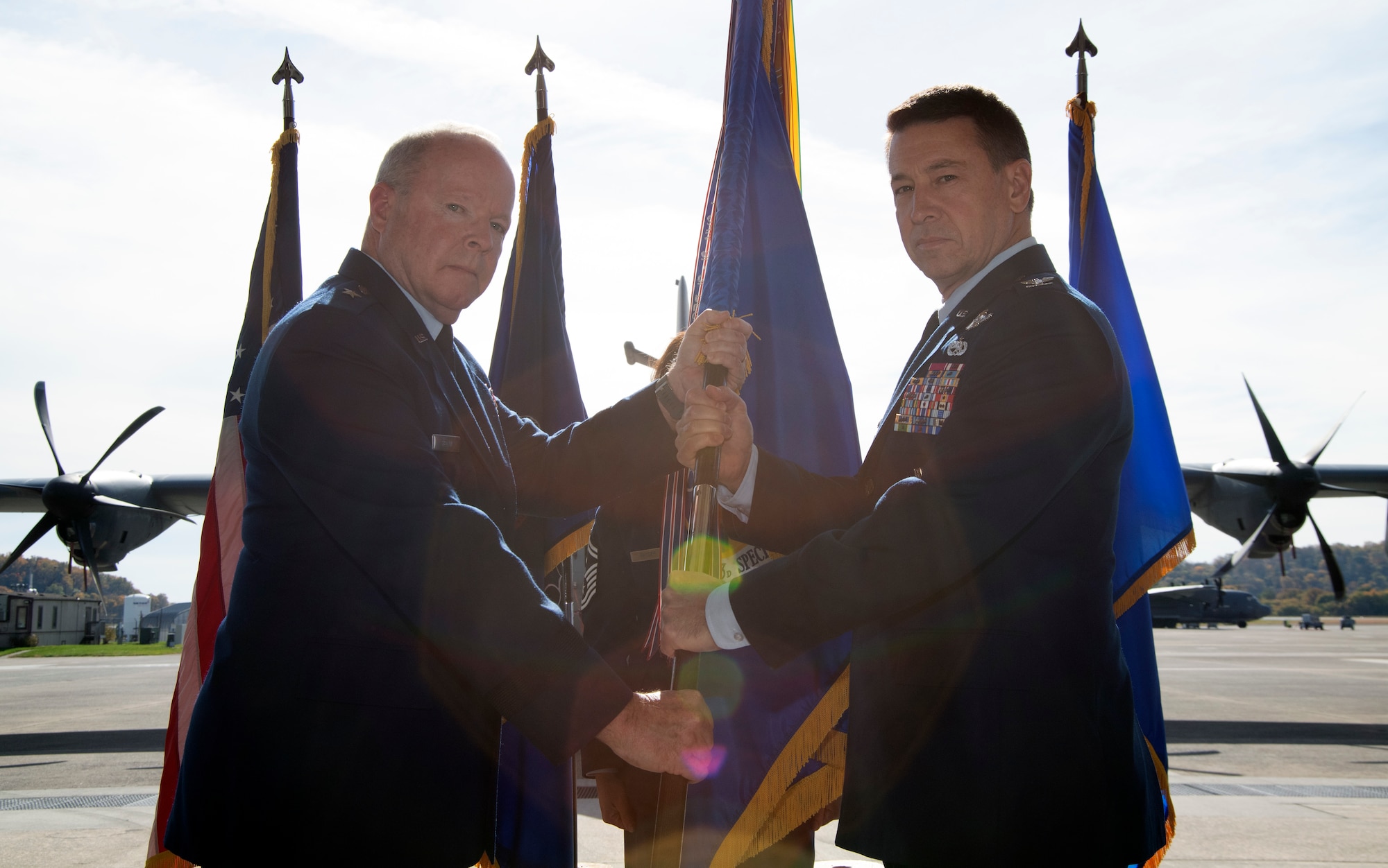 Brig. Gen. Michael Regan, Pennsylvania Air National Guard commander (left) and Col. Edward Fink Jr., 193rd Special Operations Wing commander (right) exchange the guidon at an assumption of command ceremony Oct. 28, 2022, Middletown, Pennsylvania.