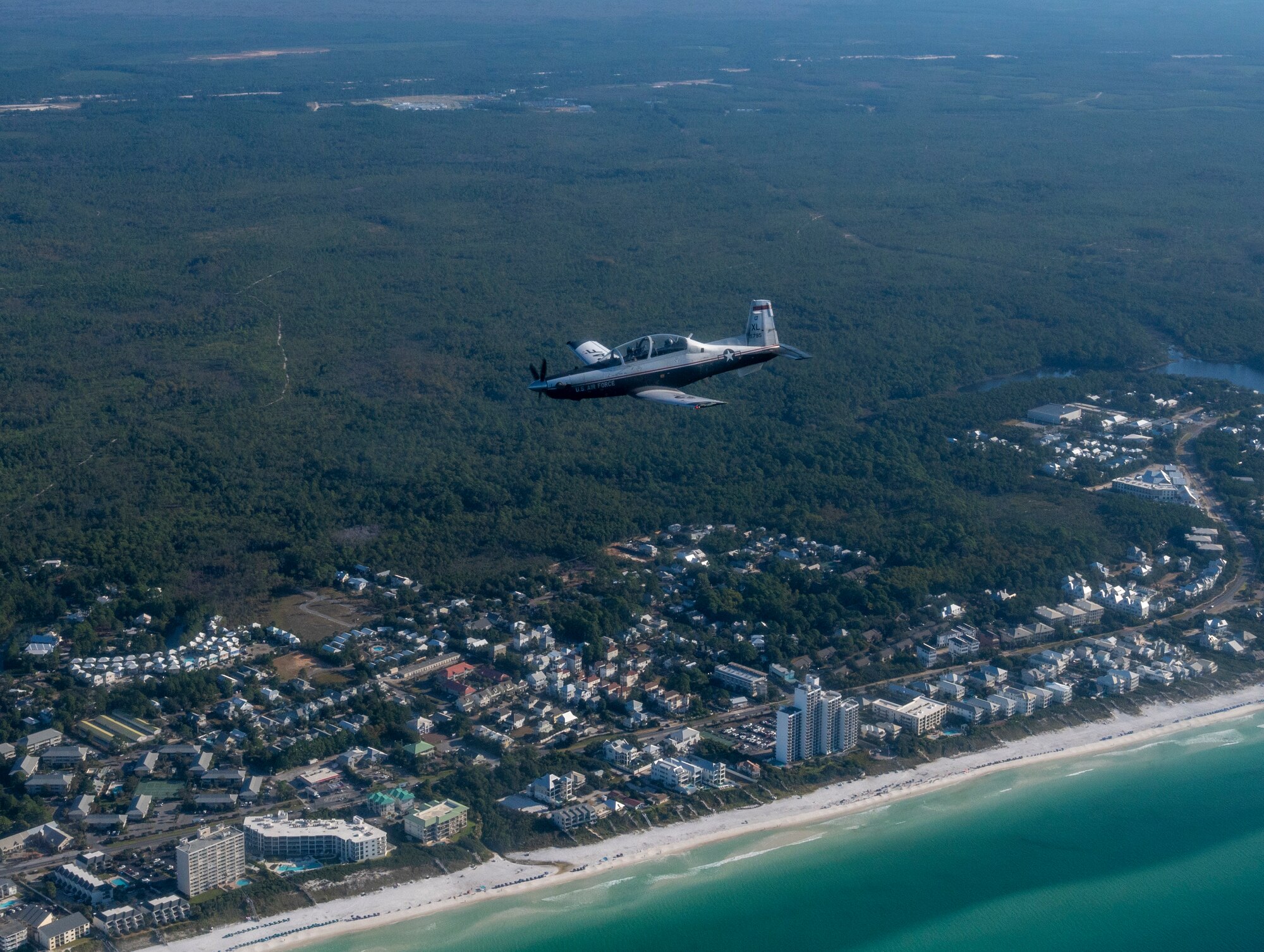 A T-6 Texan II flies above the coastline from MacDill Air Force Base, Florida, to Eglin Air Force Base, Florida, as part of Ambush Florida on Oct. 13, 2022. Ambush Florida is a mission where pilots from the 85th Flying Training Squadron fly to a different region of the U.S. and "ambush" other bases helping pilots gain experience in long distance flights. (U.S. Air Force photo by Senior Airman Nicholas Larsen.)
