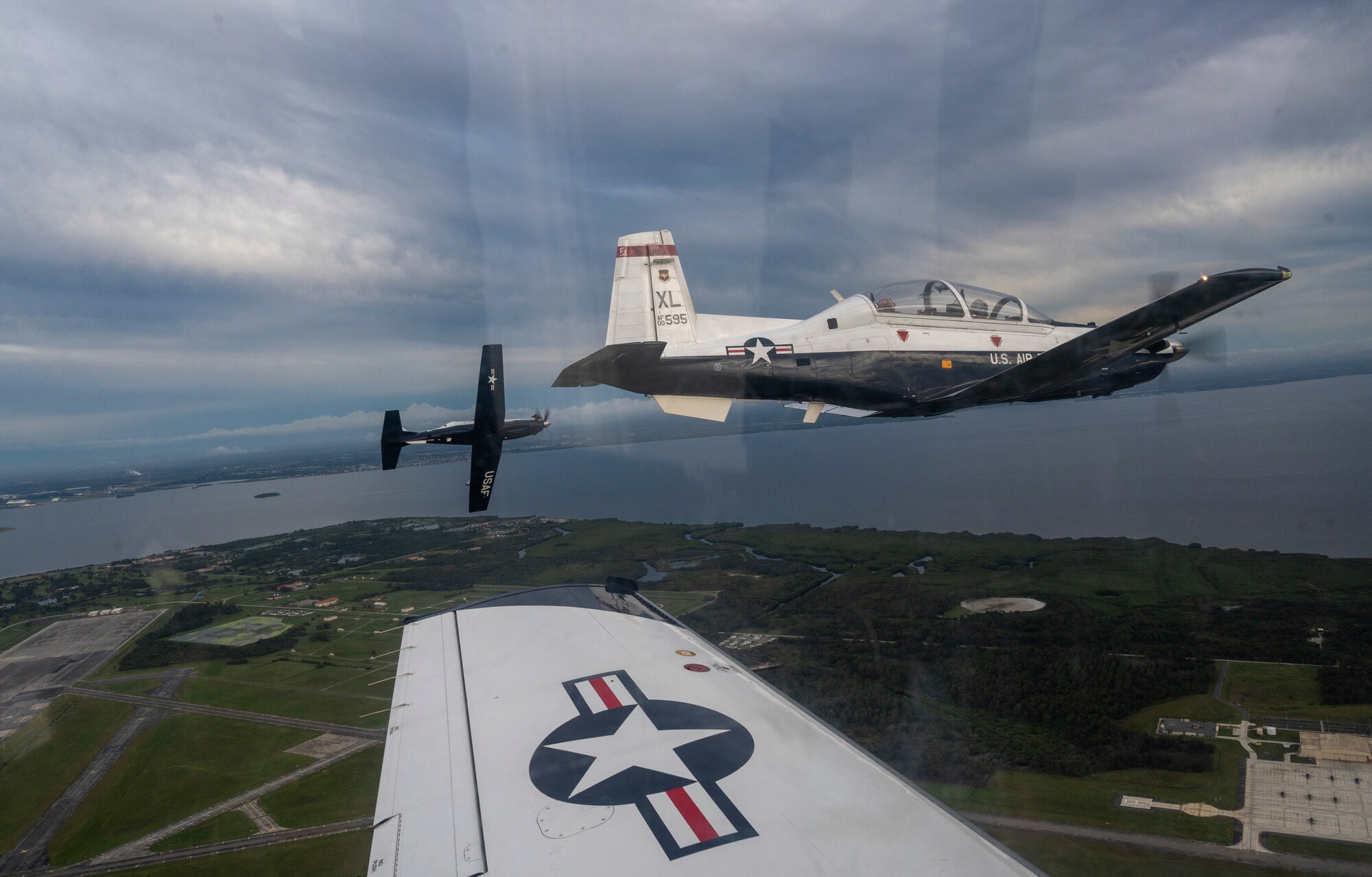A flight of T-6 Texan II's turn to land at MacDill Air Force Base, Florida, as part of Ambush Florida on Oct. 13, 2022. Ambush Florida is a mission where pilots from the 85th Flying Training Squadron fly to a different region of the U.S. and "ambush" other bases helping pilots gain experience in long distance flights. (U.S. Air Force photo by Senior Airman Nicholas Larsen.)