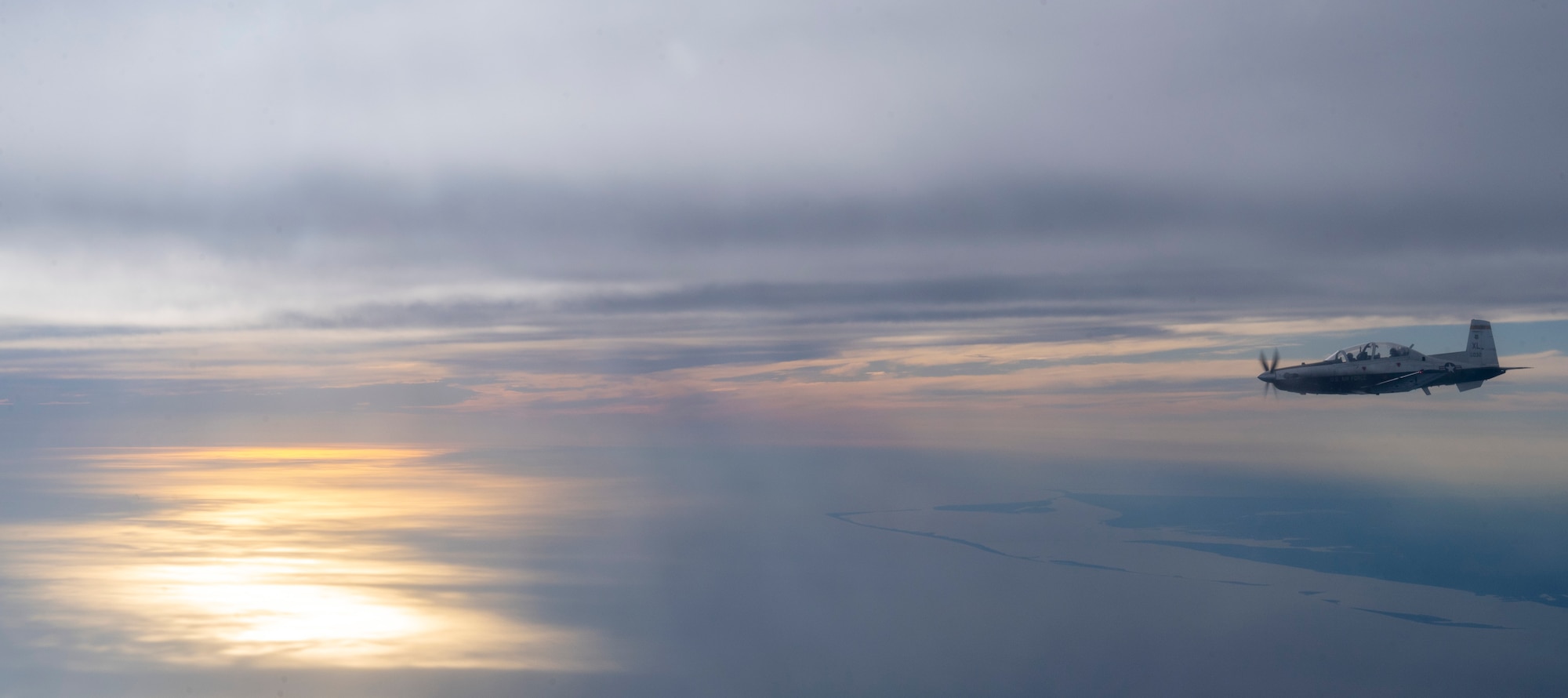 A T-6 Texan II flies from Laughlin Air Force Base, Texas, to MacDill Air Force Base, Florida, as part of Ambush Florida on Oct. 13, 2022. Ambush Florida is a mission, where pilots from the 85th Flying Training Squadron fly to a different region of the U.S. and "ambush" other bases helping pilots gain experience in long distance flights. (U.S. Air Force photo by Senior Airman Nicholas Larsen.)