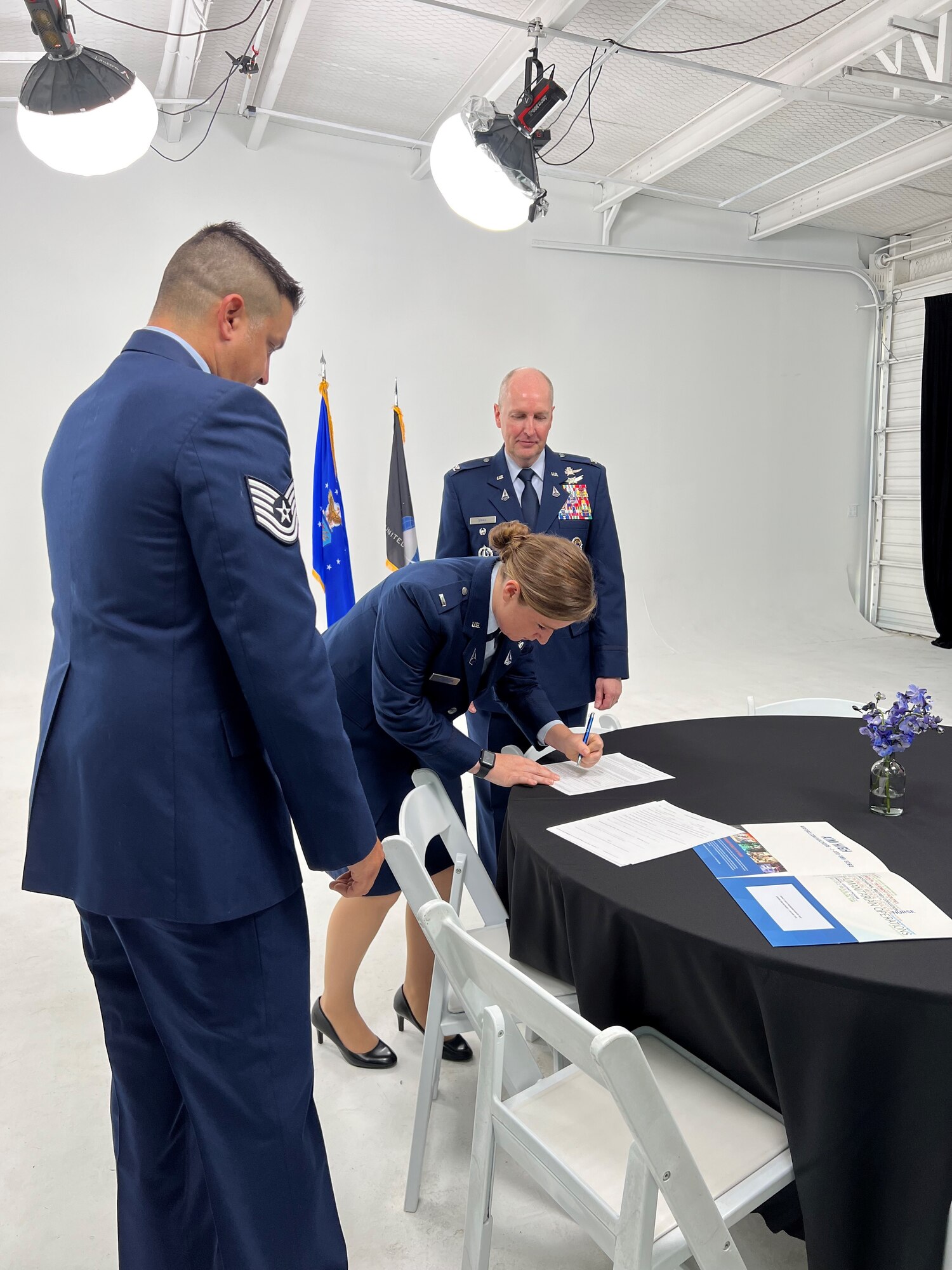 2nd Lt. Jessica Thompson, center, signs her official commissioning documents