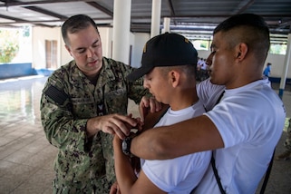 Hospital Corpsman 3rd Class Sebastian Gonzalez-Lores, left, from New Braunfels, Texas, attached to the Military Sealift Command hospital ship USNS Comfort (T-AH 20), teaches tactical carrying techniques to Guatemalan service members during a tactical combat casualty care subject matter expert exchange in Puerto Barrios, Guatemala, Oct. 27, 2022.